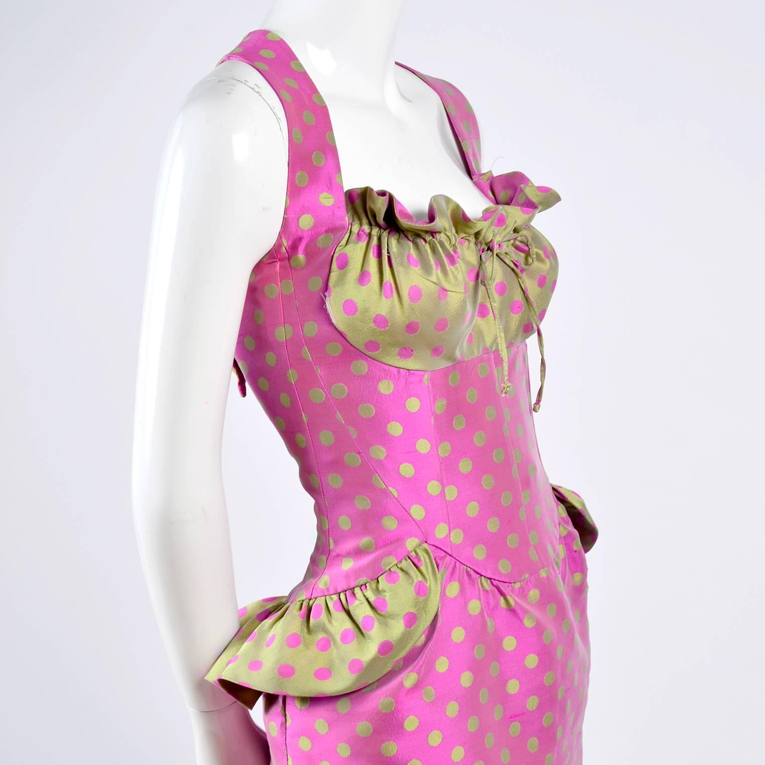 This vintage Christian Lacroix dress is from an early 1990's Spring Summer collection and is in one of his iconic styles. The dress is pink with lime green dots and the gathered bust area and ruffled side peplums are in green with pink dots.  We