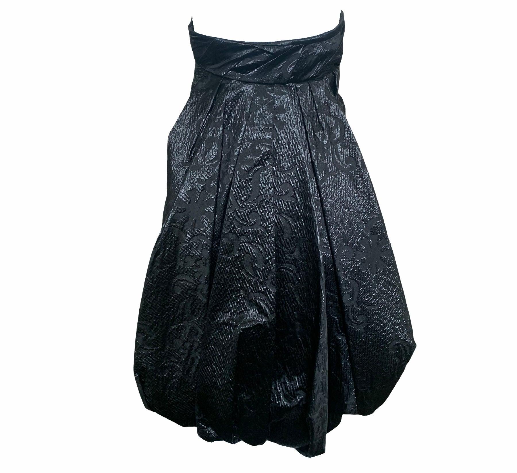 Super stunner by Christian Lacroix. Black strapless cocktail dress in matelasse and organza with velvet empire waist bacd.  Built in corselet.  Signature bubble hem. Peekaboo panel of oversize black paillettes. Looks great coming and going. New with
