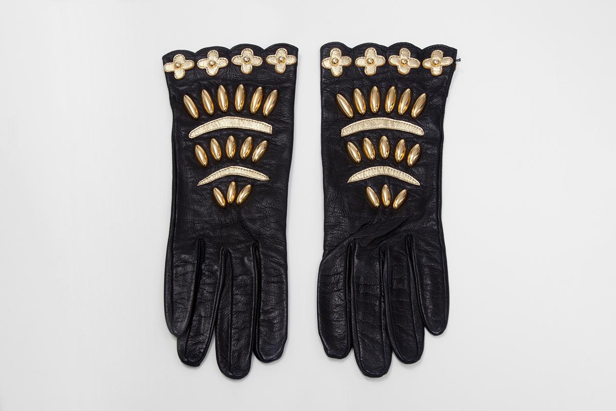 Keep your hands warm and chic with this wonderful vintage Christian Lacroix gloves. Crafted in France from supple black leather and decorated with gold studs and matching gold leather flowers at the cuffs, the pair is fully lined with silk for a