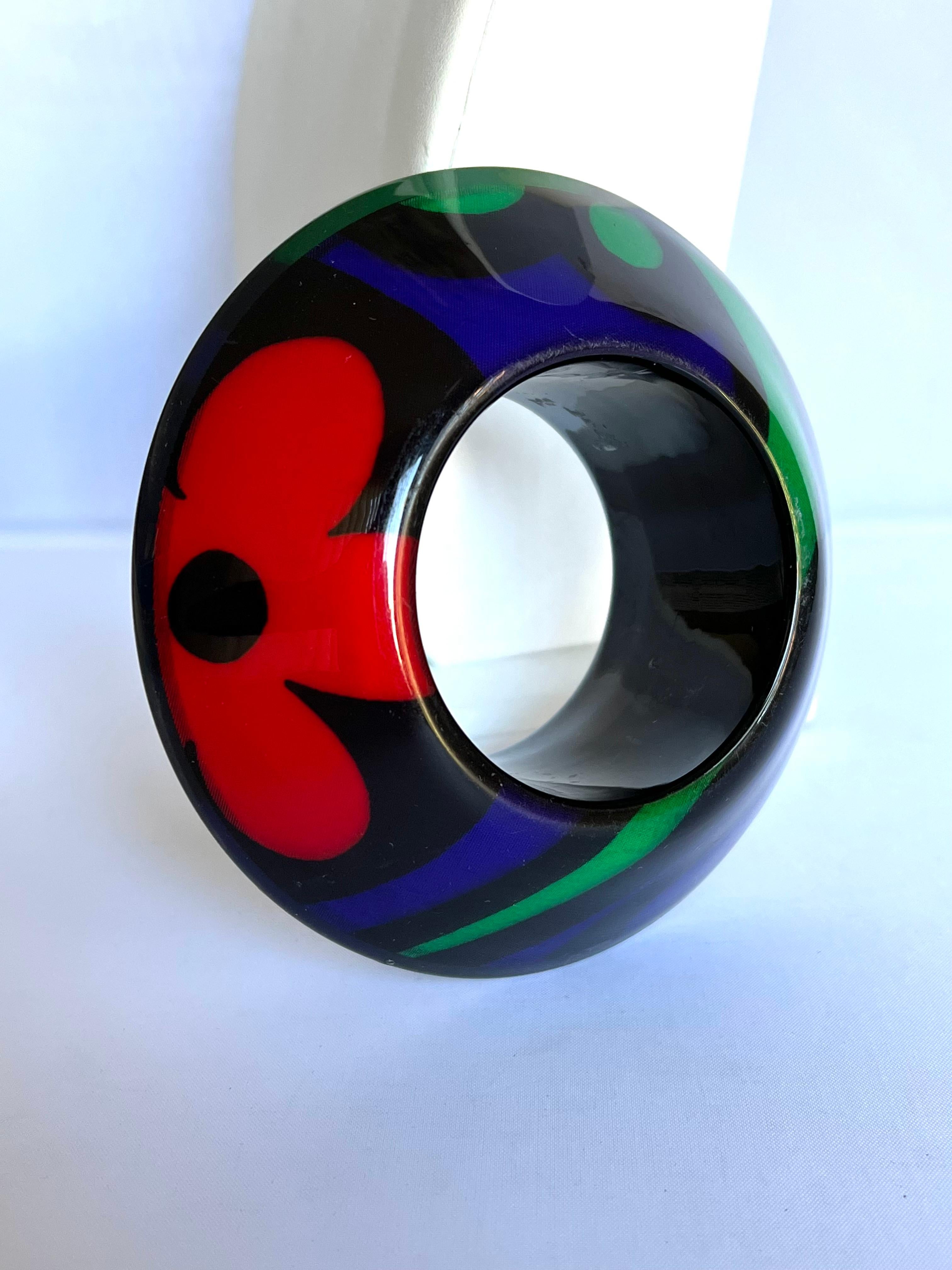 Spectacular substantial high fashion Christian Lacroix black enamel bangle bracelet featuring a bold and colorful (blue, green, and red) floral pattern - signed Christian Lacroix (ready-to-wear collection spring/summer 1992) please see the last