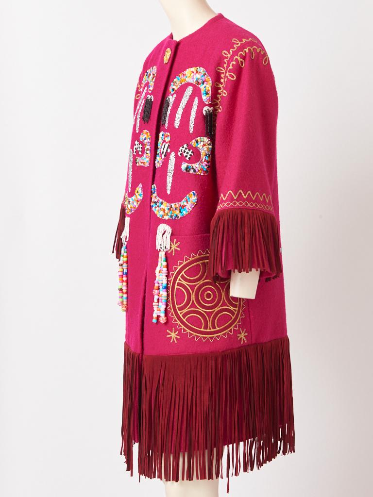 Christian Lacroix,  fuchsia tone, collarless, wool, coat having  a deep suede fringe at the hem and end of sleeves. Coat has large patch pockets with gold embroidery. Libertine, upcycled the coat by  adding colorful abstract, graphic patterns of