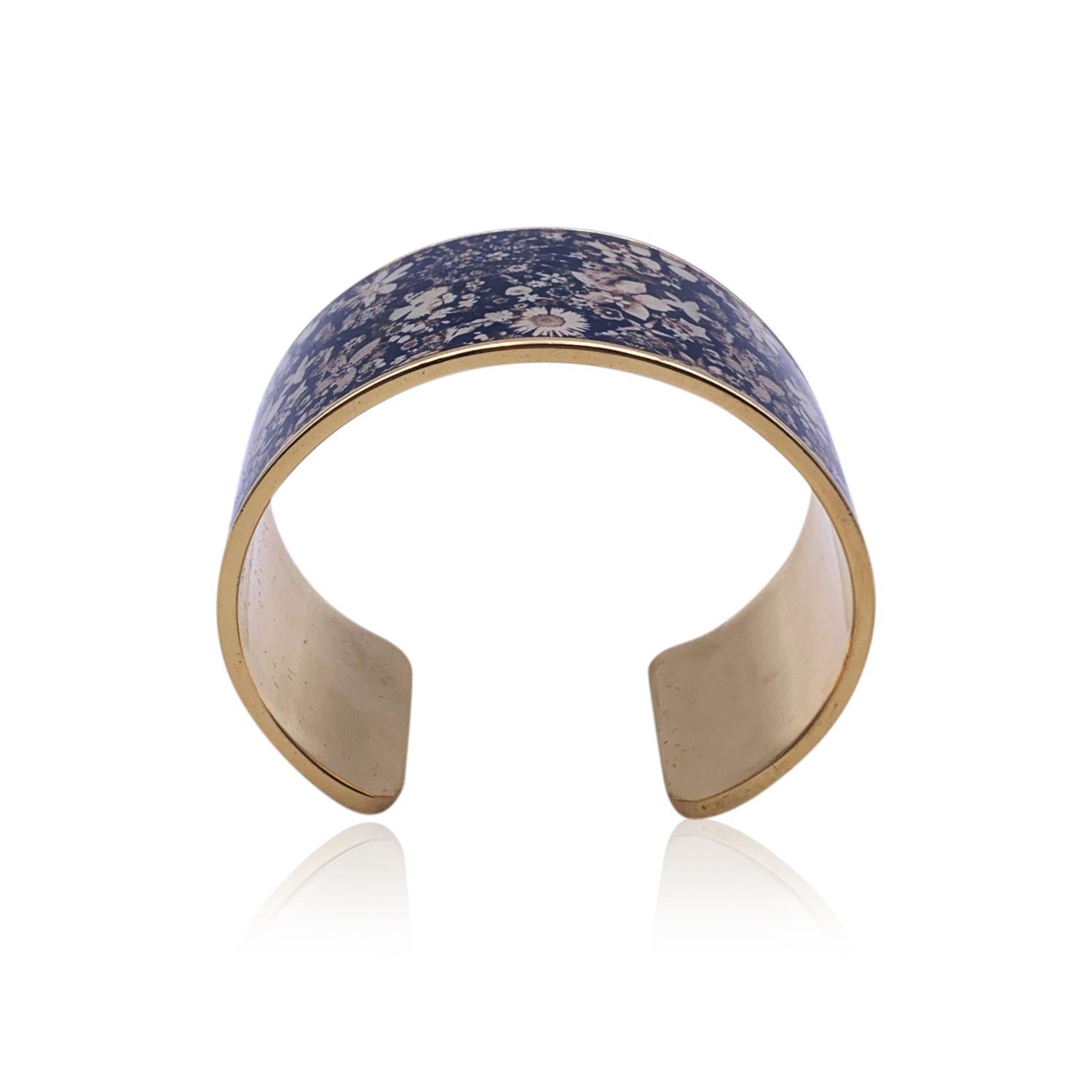 Beautiful cuff bracelet by Christian Lacroix, from the 'Jardin de Songes' Line. Made in gold-tone metal with a floral lacquer top. Will fit up to approx. 7 inches - 17.8 cm wrist. Max width/ Inner diameter: 2.5 inches - 6.4 cm. Width: 3.4 cm.