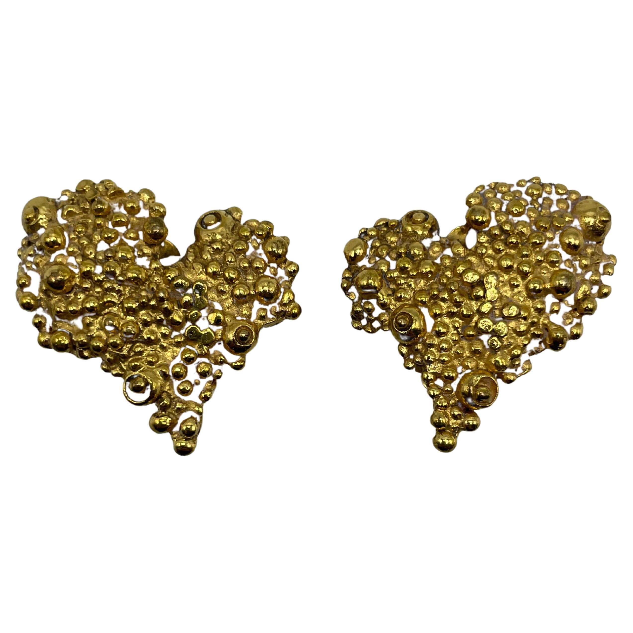 Christian Lacroix heart shaped gold toned clip-on earrings. The heart-shaped pattern on the earrings, which Christian Lacroix frequently employed to create his jewelry, is a representation of his creative aesthetic. Made in France and bearing the