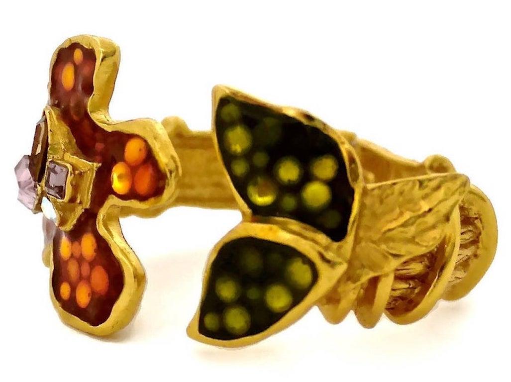 Vintage CHRISTIAN LACROIX Iridescent Flower Rhinestone Enamel Rigid Bracelet Cuff

Measurements:
Height: 1.46 inches (3.7 cm)
Circumference: 6.30 inches (16 cm)

Features:
- 100% Authentic CHRISTIAN LACROIX.
- Iridescent enamel flower and leaves