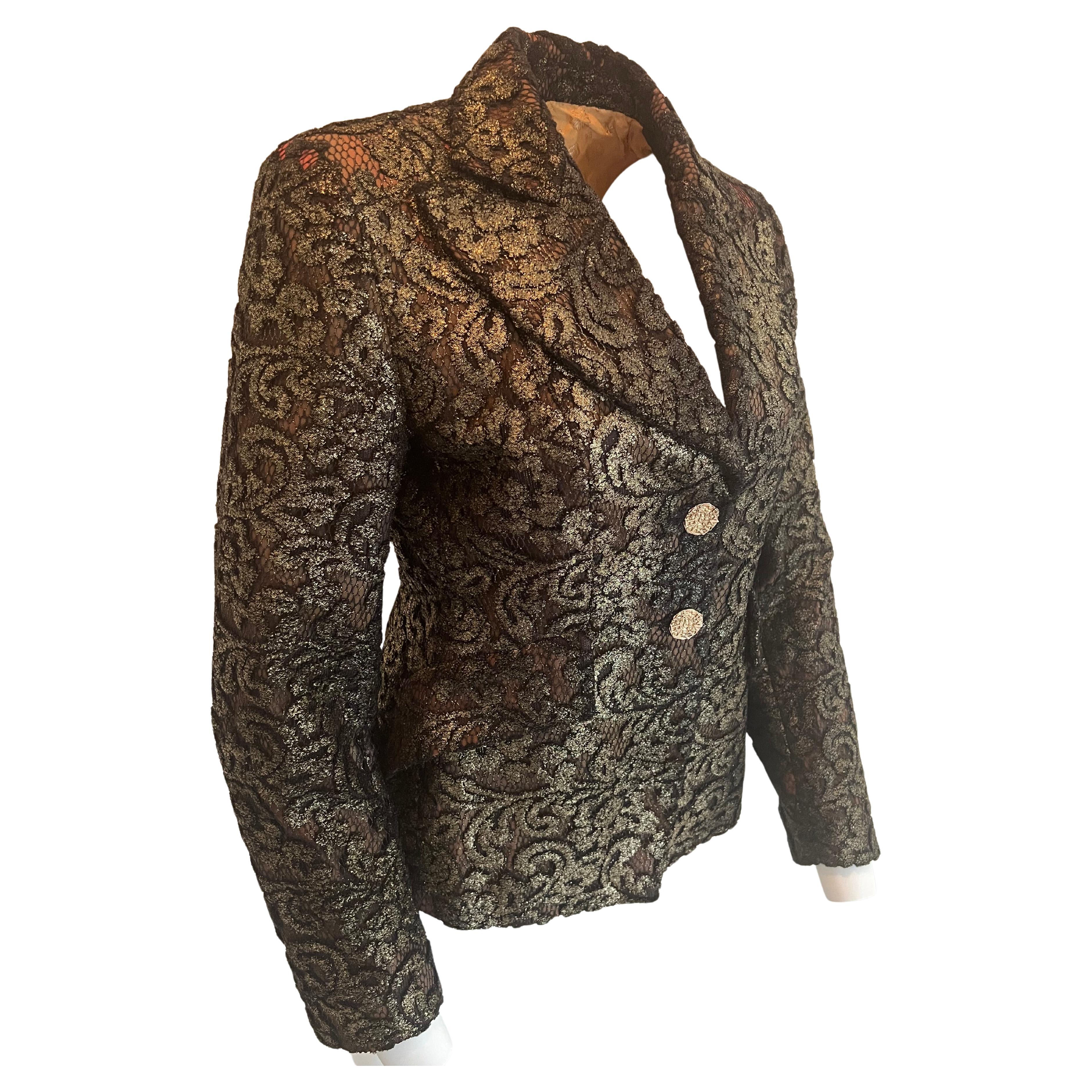 Christian Lacroix BAZAR made in France. Jacket in black and gold lace with a few red shades in the lace lining fitted cut, large slanted pocket stiff collar, cutout with two buttons on the back.