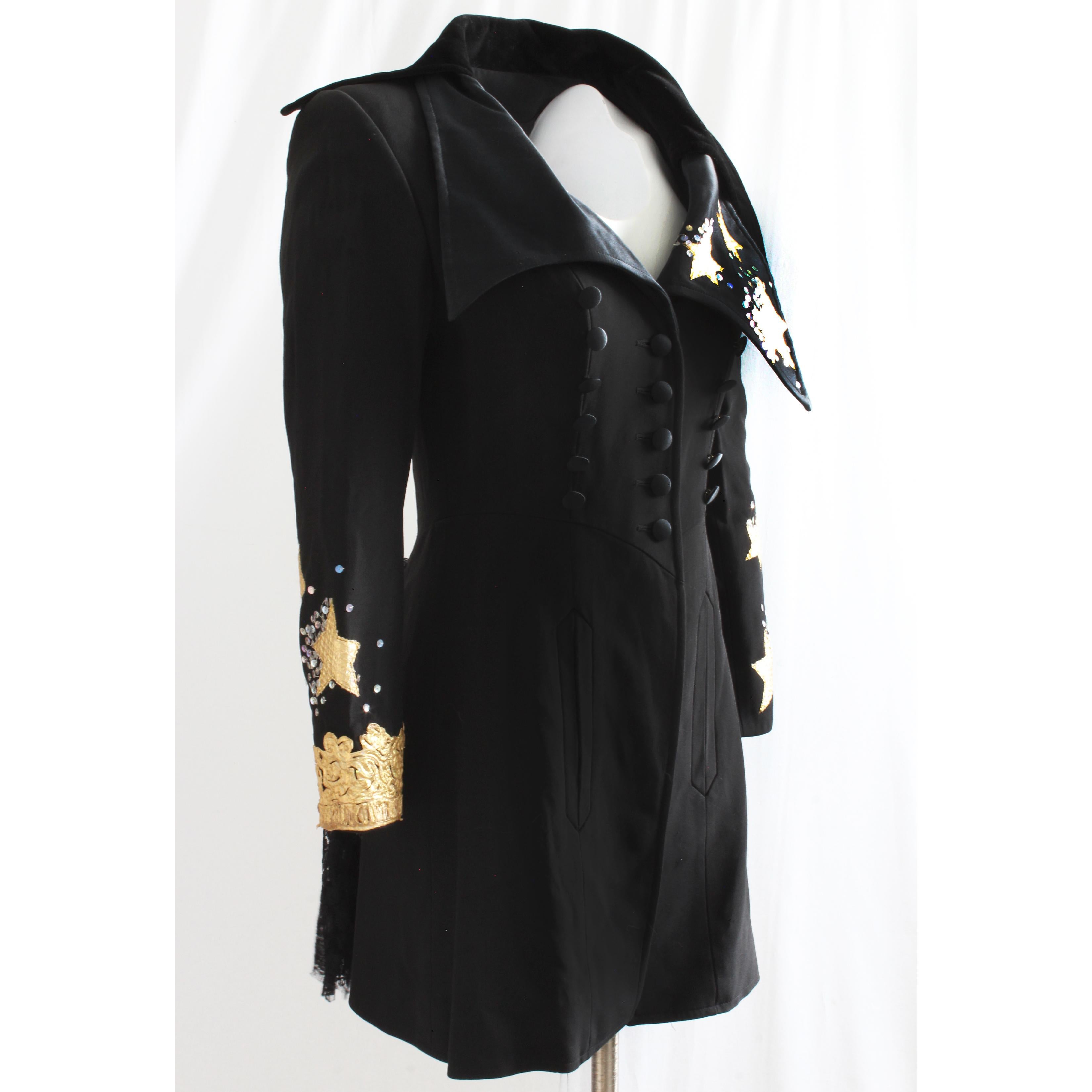 This fabulous long structured jacket was designed by Christian Lacroix, most likely in the early 90s. Made from a viscose blend garbardine, the large lapel collar is made from black velvet and features snakeskin embroidery stars, gold embroidery