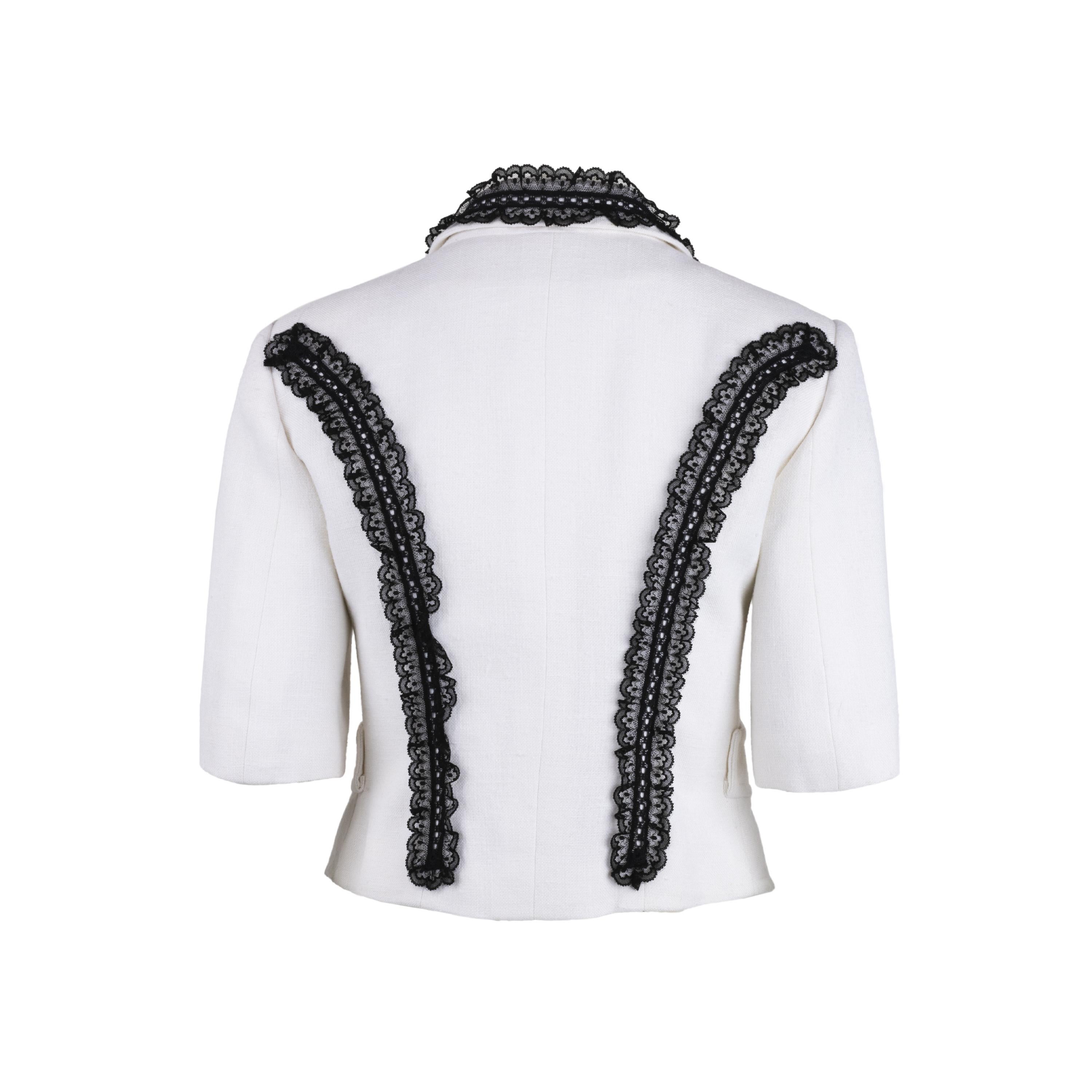 Christian Lacroix white linen jacket. Cropped style with three-quarter length sleeves decorated with black lace and heart-shaped jewel buttons.

Remarks: This garment has been customised and the sleeves have been altered.