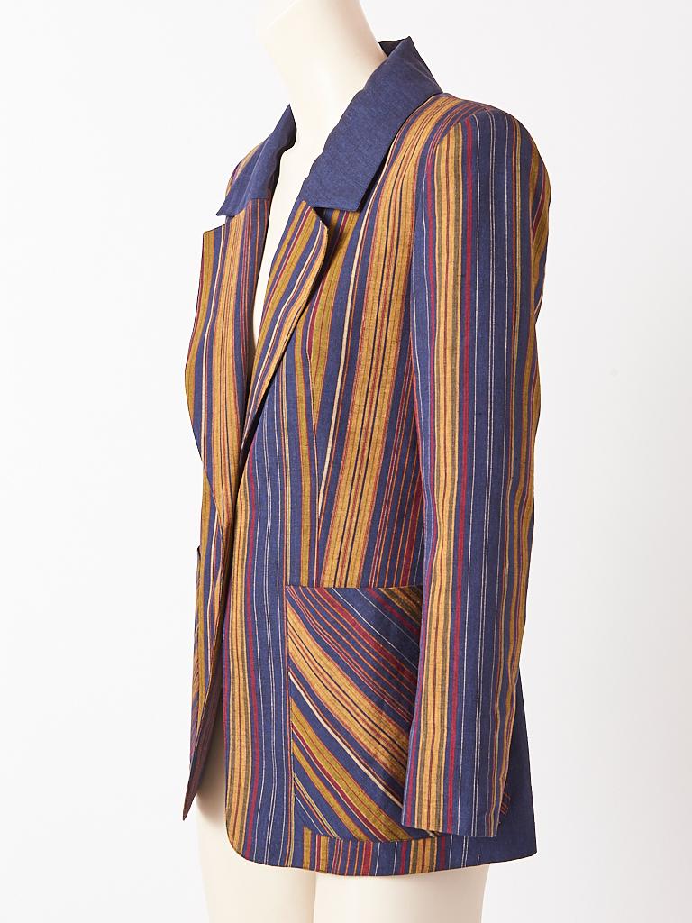 Christian Lacroix, linen and wool , fitted, single button, striped blazer in a navy and ochre stripe. Deep patch packet have diagonally placed stripe creating optical interest. Back of jacket has the stripe placed in a chevron pattern.  Blazer has