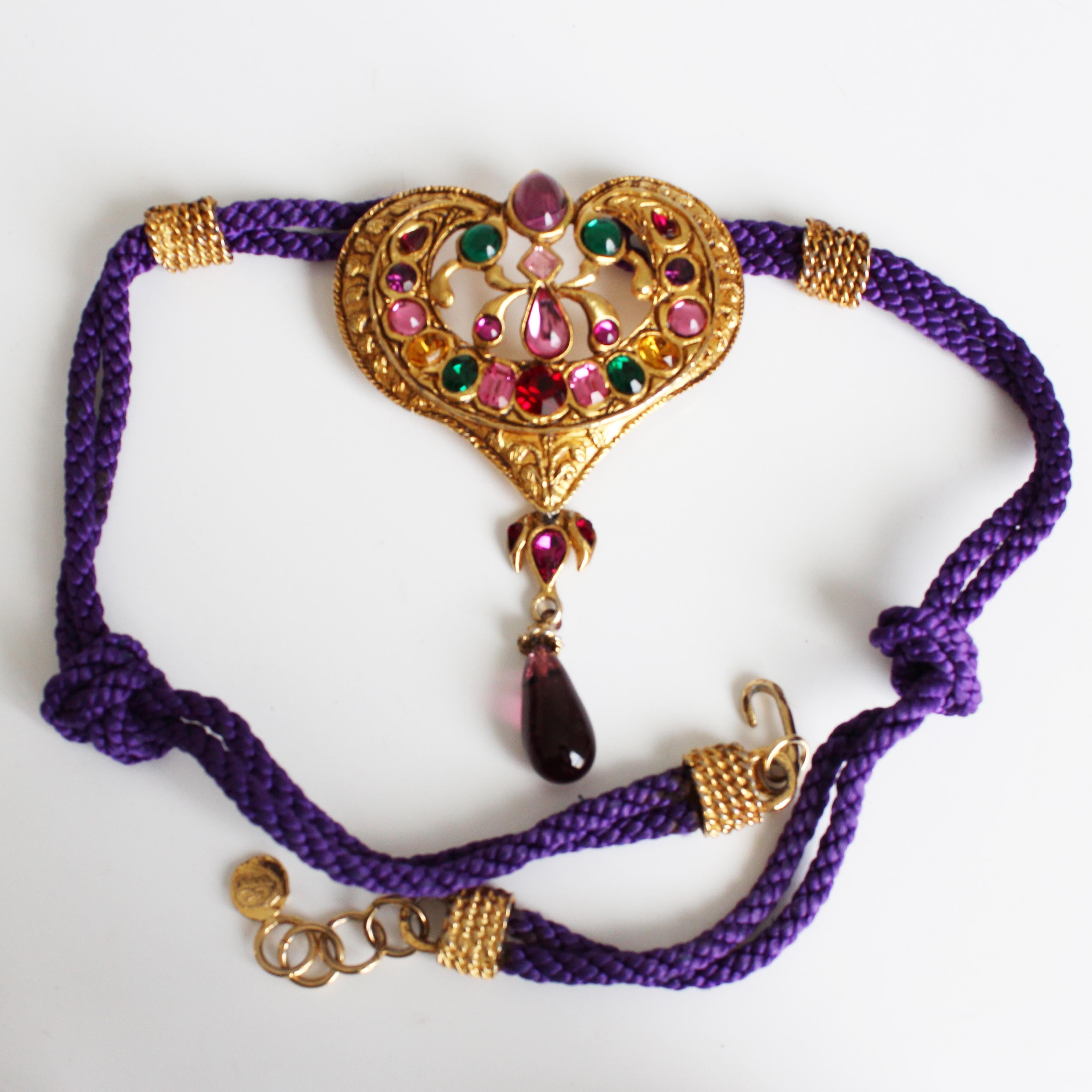 Preowned, authentic, vintage heart pendant necklace by Christian Lacroix, likely made in the 90s. A truly unique piece! It features a large 4.5in H gold metal heart with colorful glass stones & rhinestones. The necklace is fashioned from silky