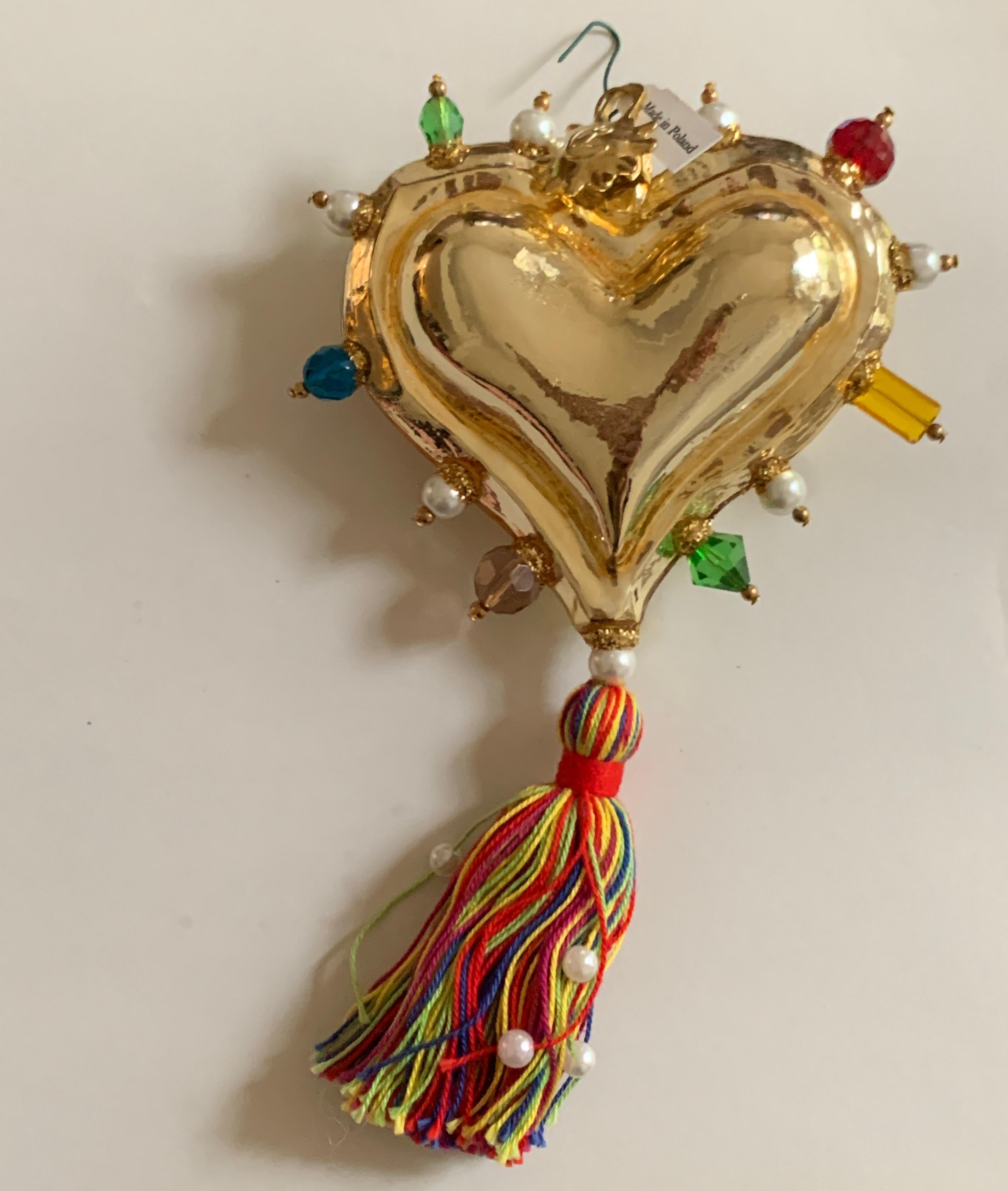 Christian Lacroix gold mouth blown and hand painted glass heart ornament with bead accents and a multicolored tassel at bottom. Signed 