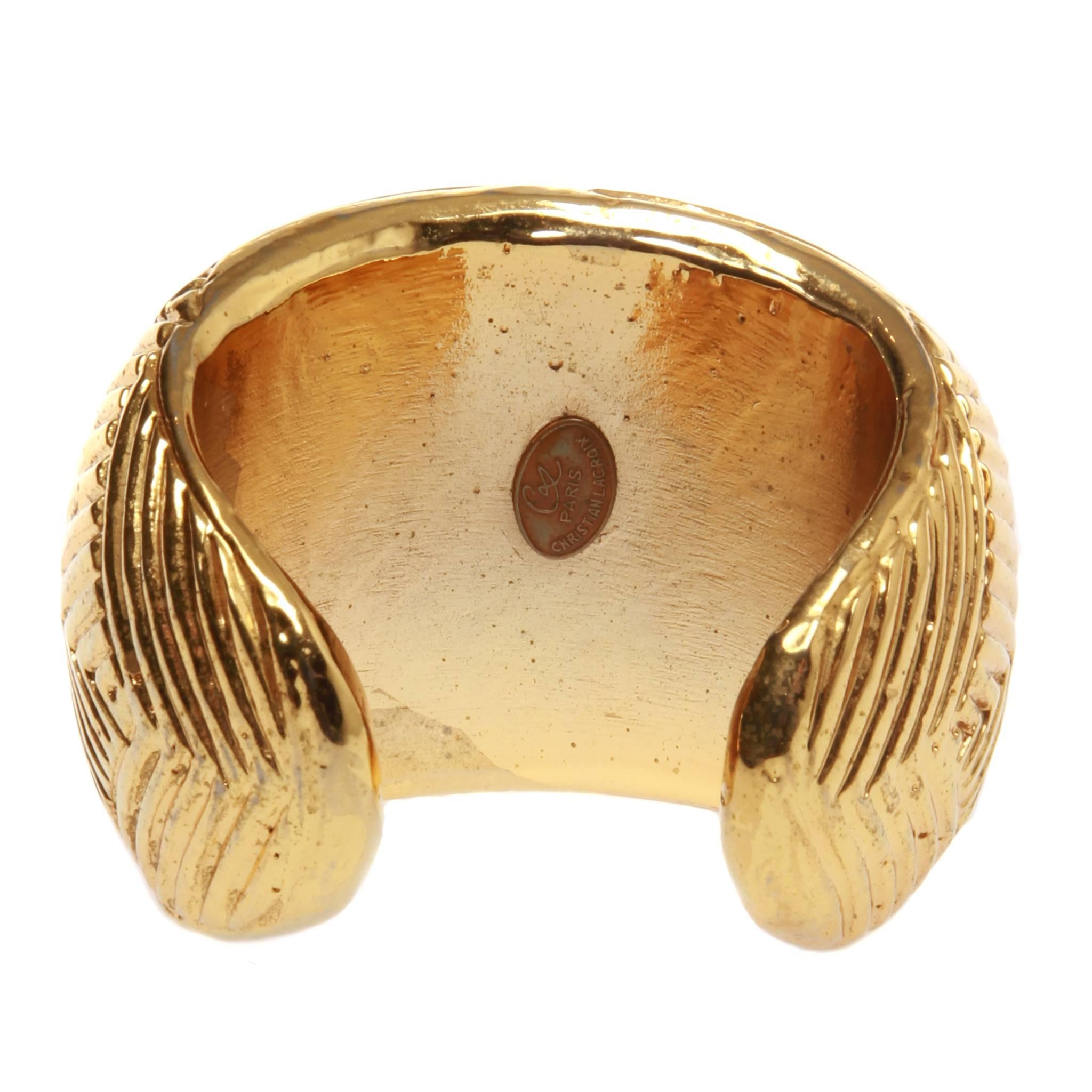 Vintage Christian Lacroix open cuff featuring a gold-tone herringbone textured surface. 