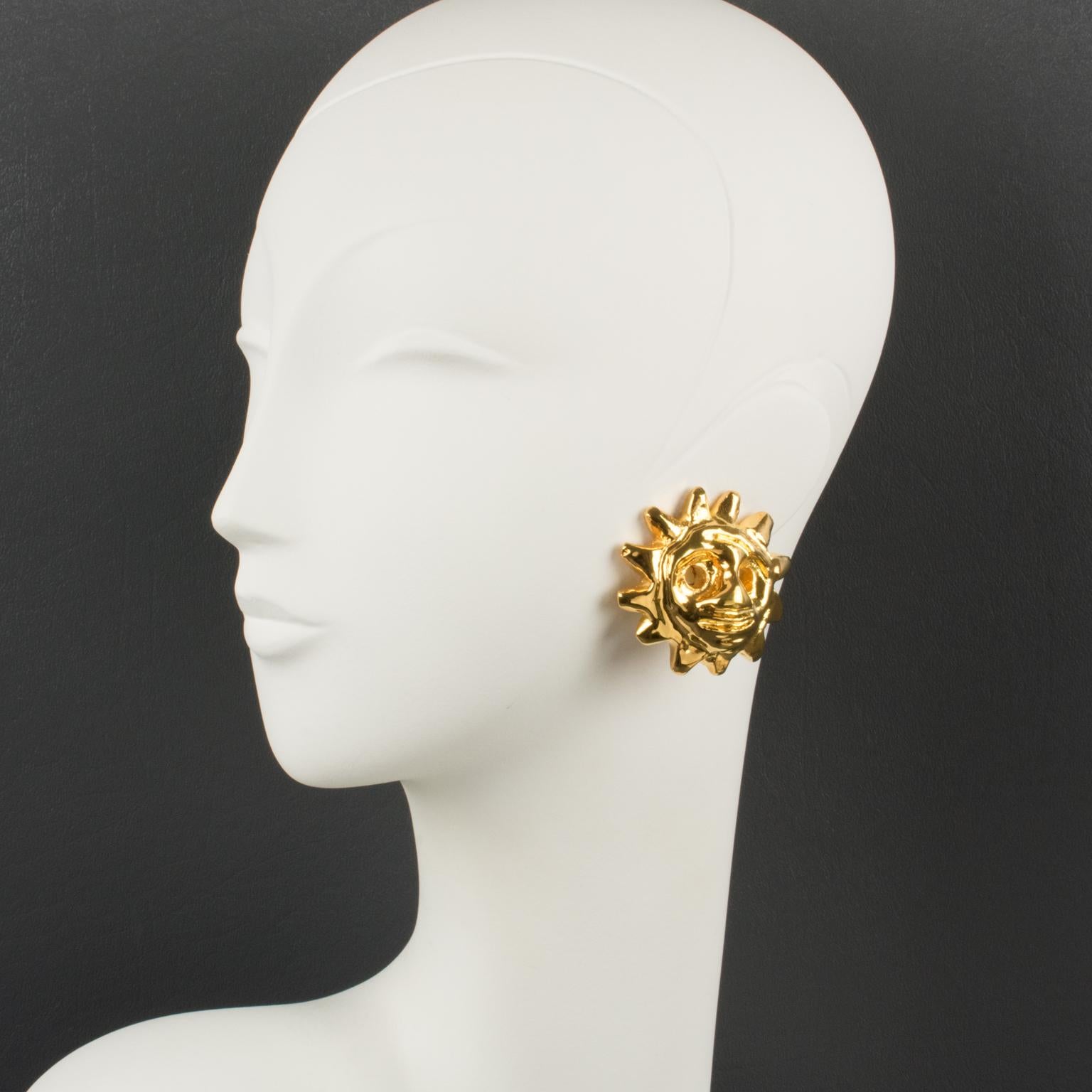 Stunning Christian Lacroix Paris signed clip-on earrings. Featuring dimensional gilt-metal coated resin sun mask with a high shine finish aspect. Marked underside: 