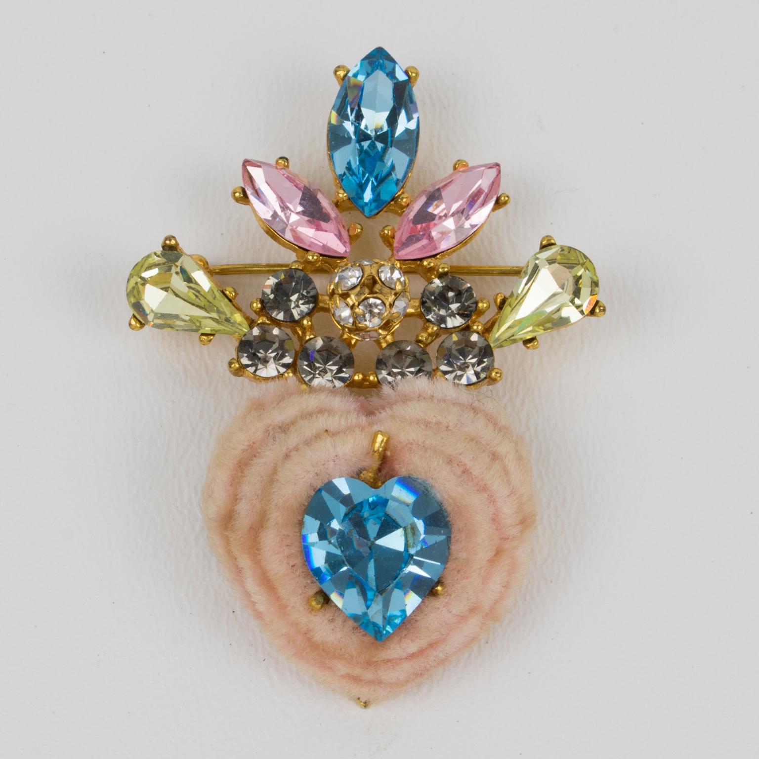 A charming Christian Lacroix Paris heart pin brooch. Romantic stylized heart shape with gilt metal framing ornate with powder pink faux fur and a large arctic blue crystal heart-shaped rhinestone on its center. The faux fur heart is topped with a