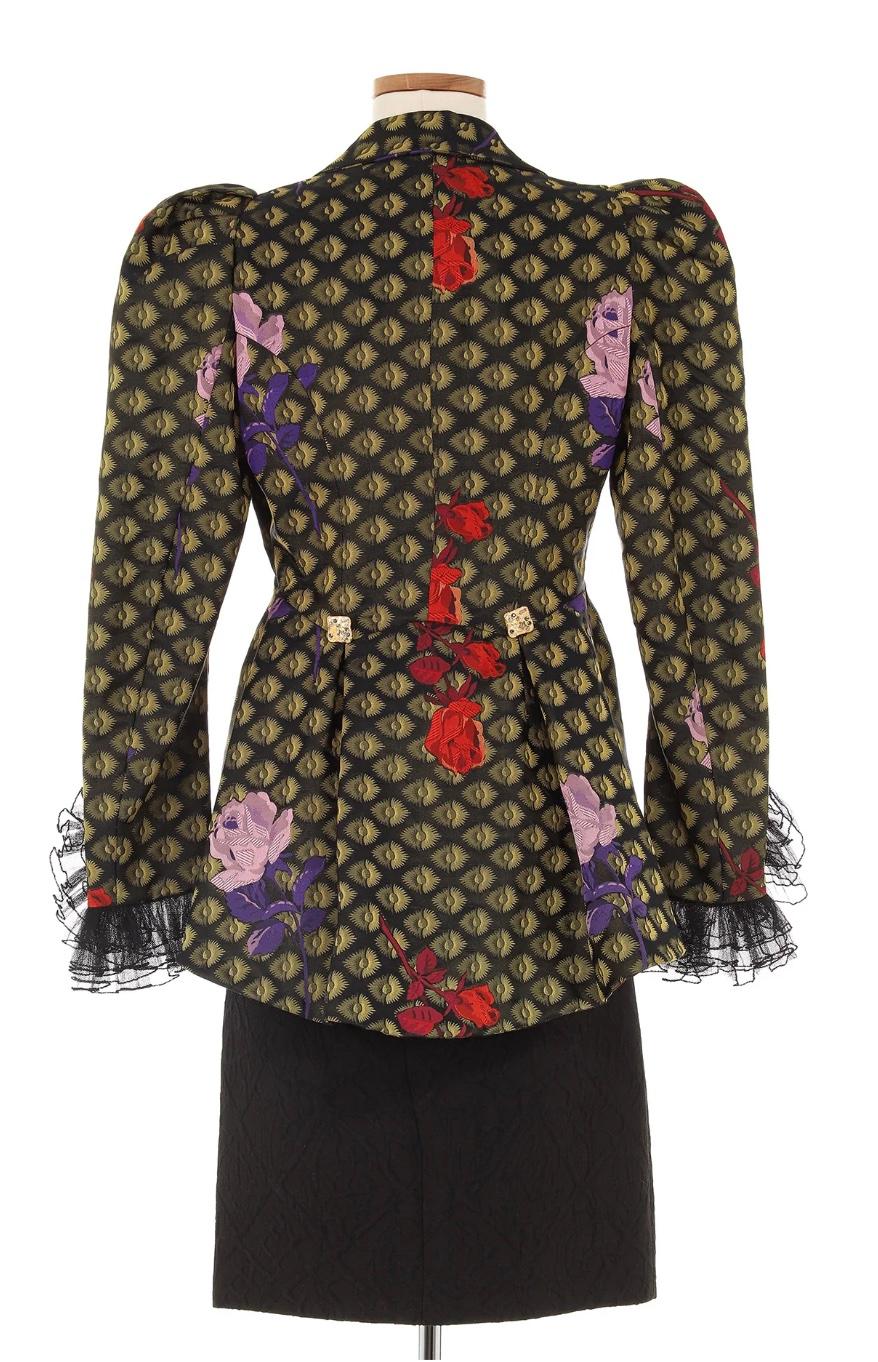 Christian Lacroix Pattern Ensemble, likely circa 1980s. This ensemble showcases brilliant detail. In an elegant pattern adorned with lace to complete the sleeves and a gold chain clasp at the front, this piece is a sophisticated show-stopper.