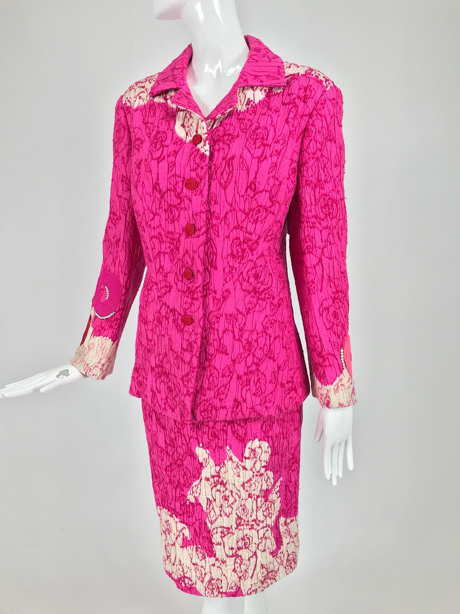 Christian Lacroix hot pink and off white embroidered silk, circle applique skirt suit from the 1990s. The jacket closes at the front with circular cord buttons, the sleeves are appliqued at the cuffs with cord circles one with a center of red