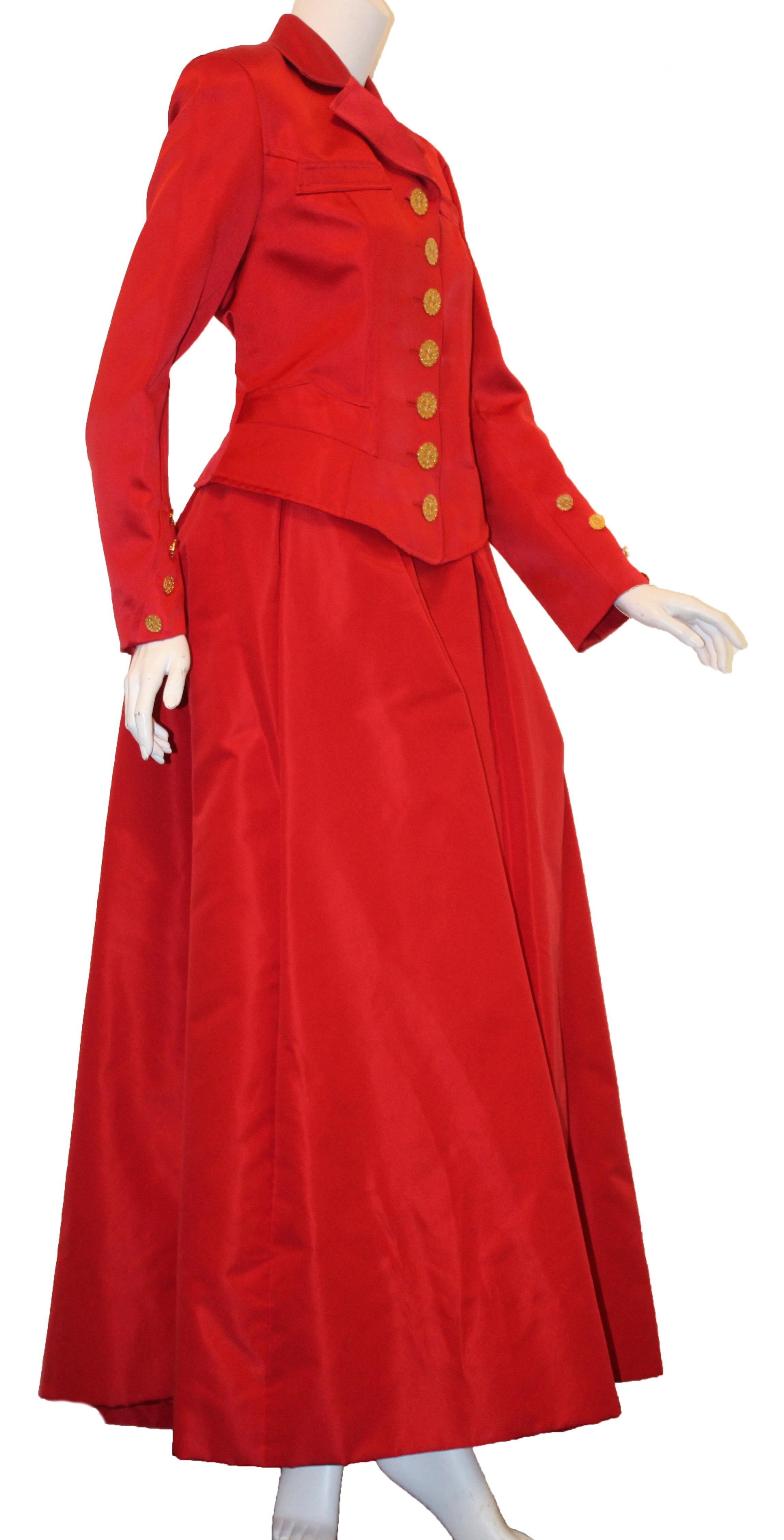 Christian Lacroix red silk outrageously dramatic two piece, jacket and skirt, ensemble contains structured shoulder pads  sewn underneath the lining.  The jacket has a high notch collar with two faux pockets on the chest and two slit pockets at he