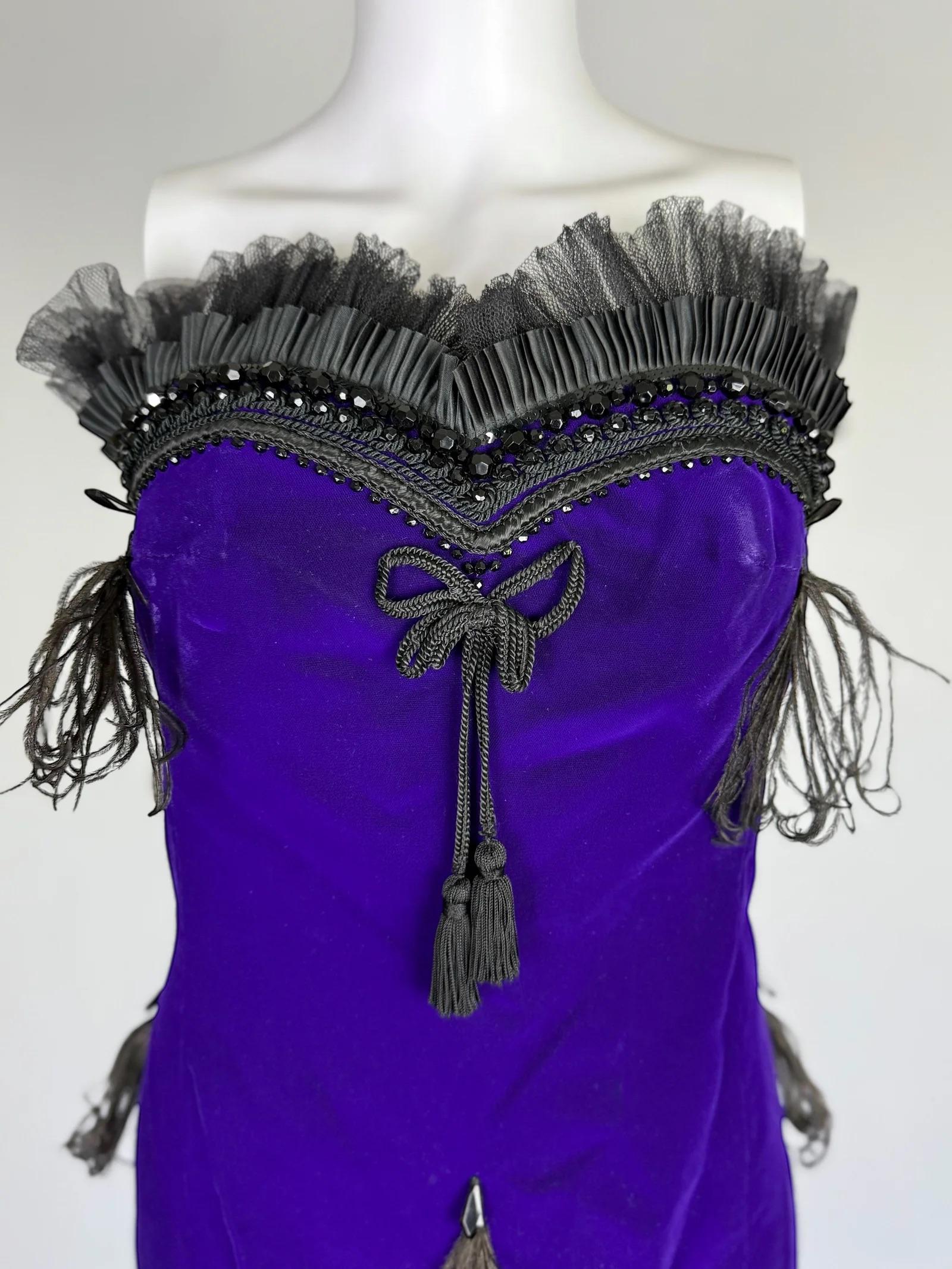 Christian Lacroix silk velvet feather dress with beading, Fall Winter 1988
Electric purple
Strapless and form-fitting, with black pleated tulle along the neckline and hem giving it a plume-like, showgirl quality
Faceted black beads and sequins form