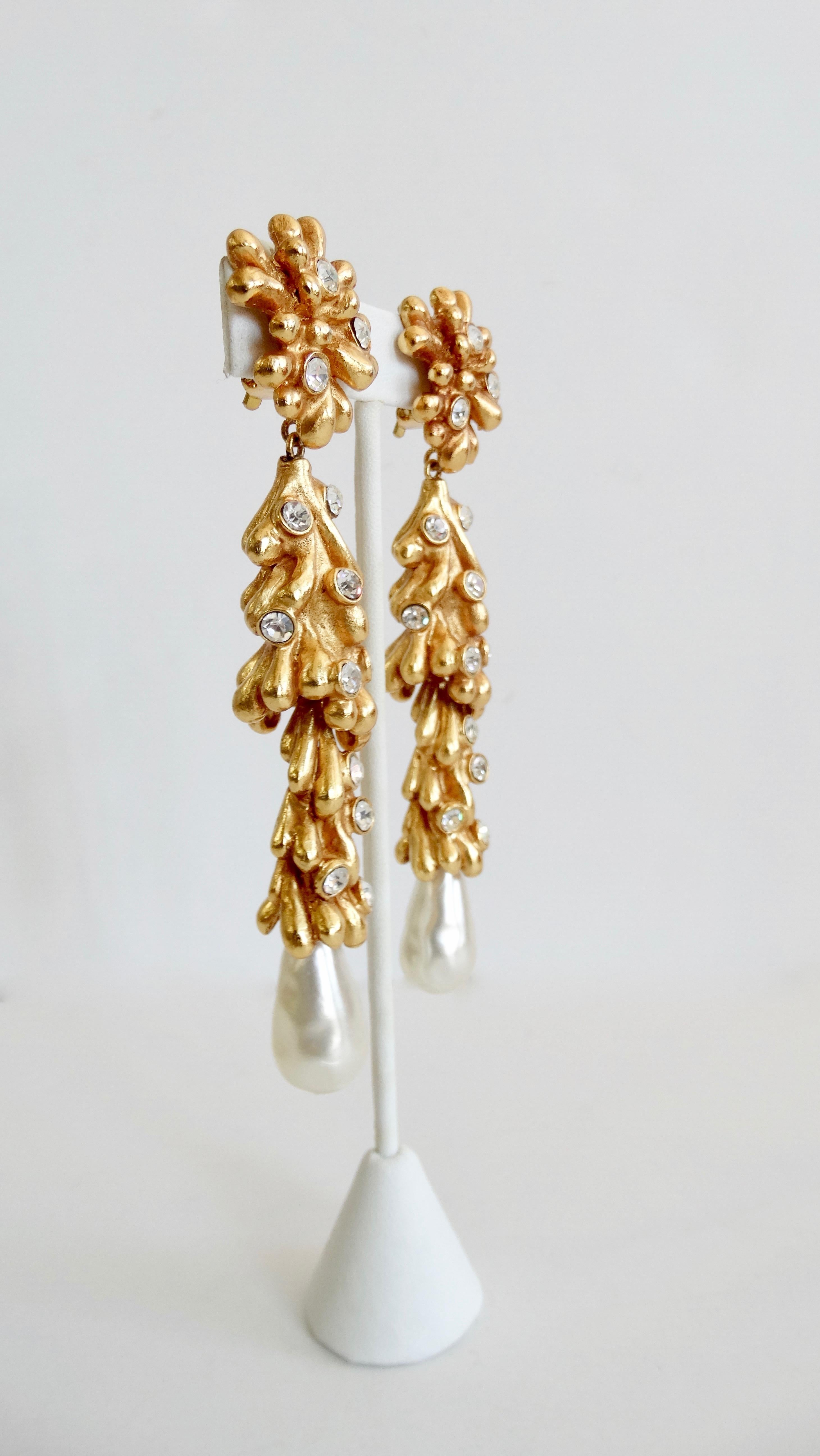 Elevate your collection with an extravagant pair of Christian Lacroix earrings! Circa 1980s, these gold plated earrings are sculpted in the shape of Sea Anemones and are embellished with rhinestones. Features a faux pearl drop and clip-on closures.