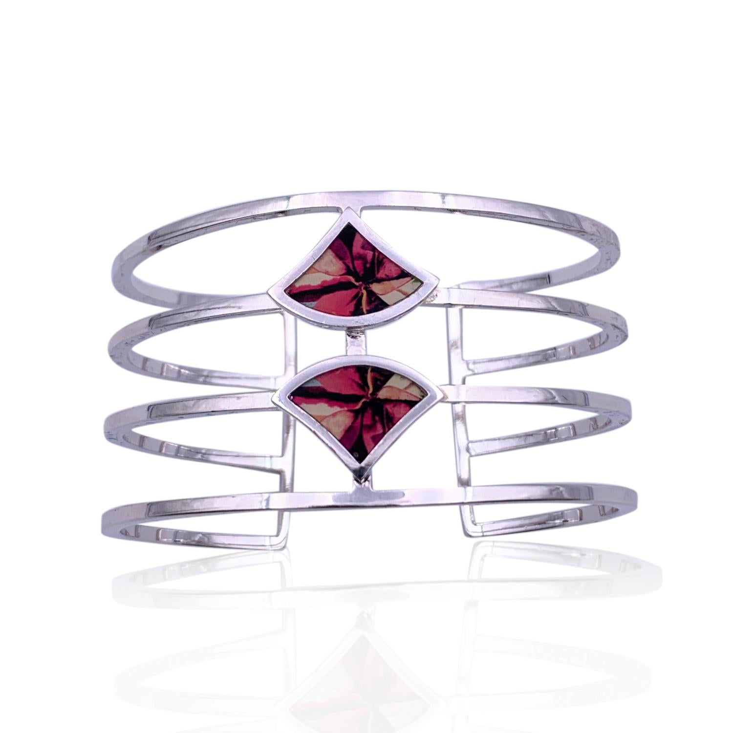 Beautiful cuff bracelet by Christian Lacroix, from the 'Terre de Feux IV' line. Made in silver-tone metal with 2 enameled elements top. Will fit up to approx. 6.25 inches - 16 cm wrist. Inner diameter: 2.25 inches - 5,6 cm. Width: 3.3 cm. 'Christian
