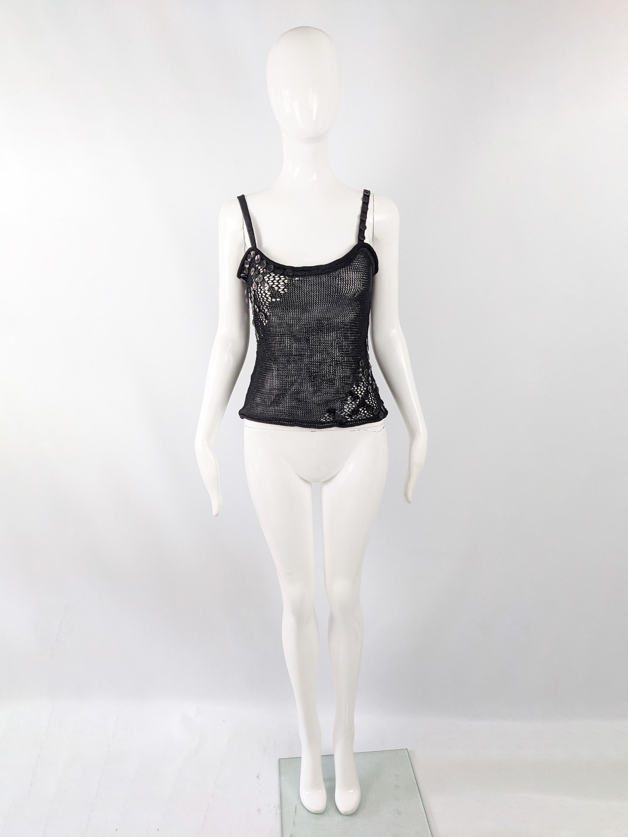 A cute vintage womens Christian Lacroix top from the late 90s. In a black open knit fabric with glossy black button details on the sides. 

Size: Marked vintage L but measures more like a womens UK 10-12/ US 6-8. Please check measurements. 
Bust -