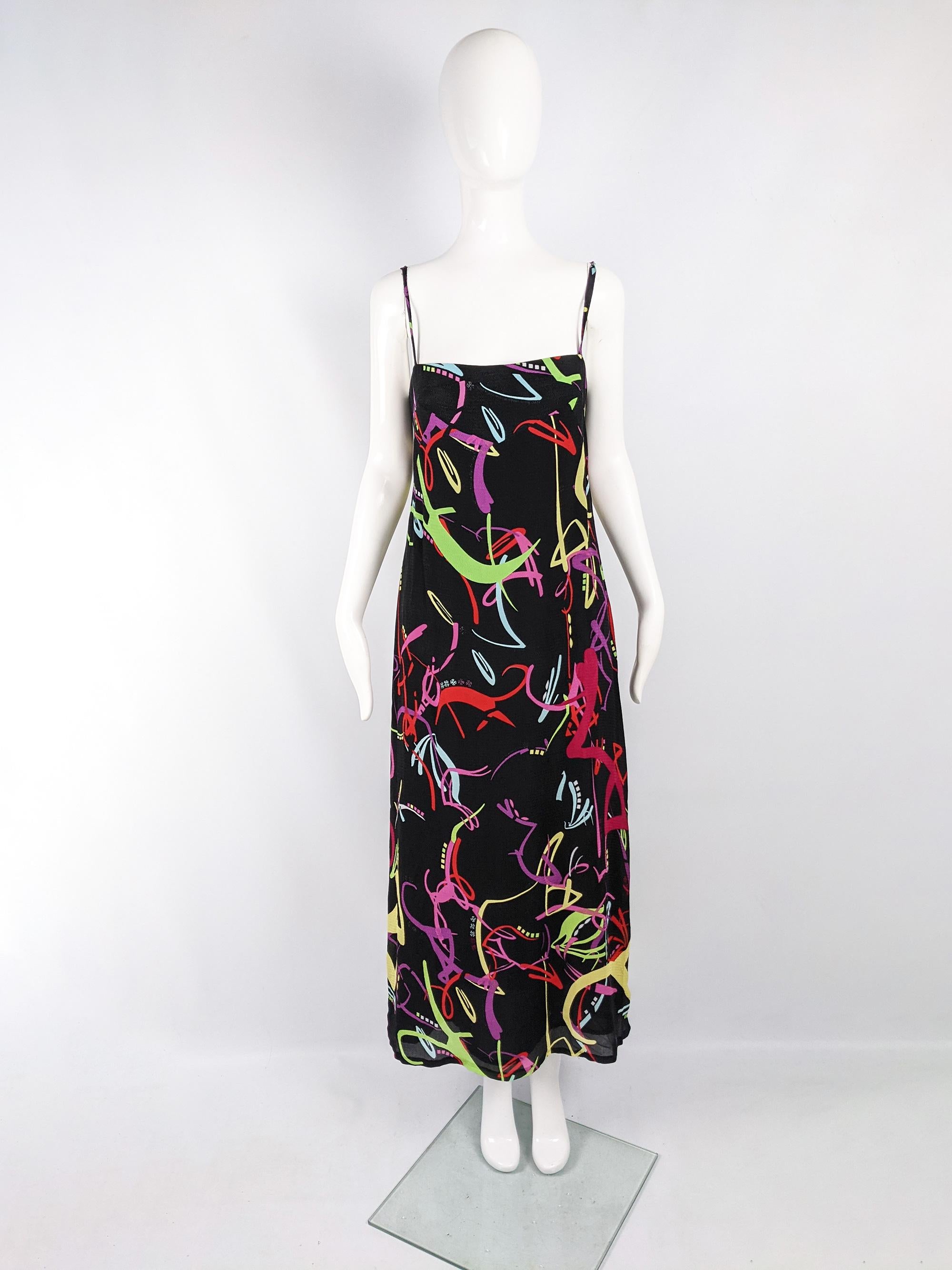 A fabulous vintage womens slip dress from the 90s by luxury French fashion designer, Christian Lacroix. In a black viscose and silk fabric which has beautiful drape, with spaghetti straps and a bold multicoloured print. 

Size: Marked vintage 42 but