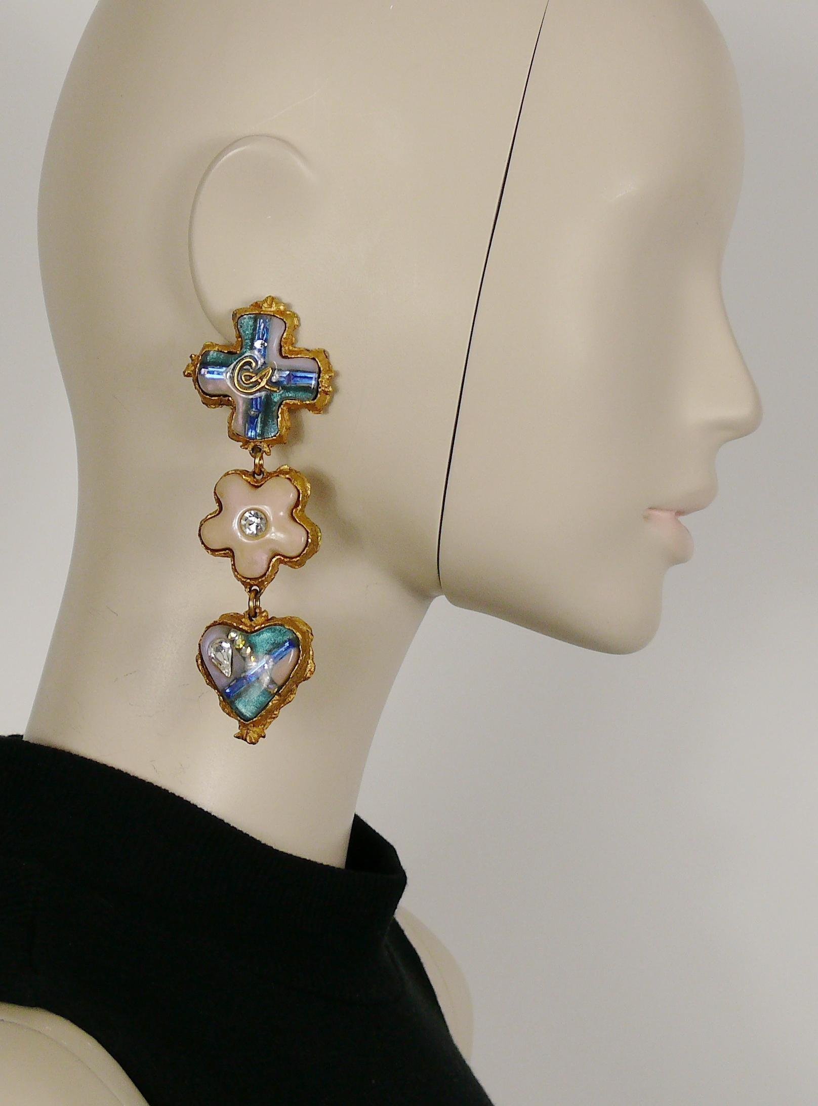 CHRISTIAN LACROIX gold toned dandling earrings (clip-on) featuring blue/pink resin inlaid heart, star and heart with crystal embellishement.

Marked CHRISTIAN LACROIX CL Made in France.

Indicative measurements : max. length approx. 10.5 cm (4.13