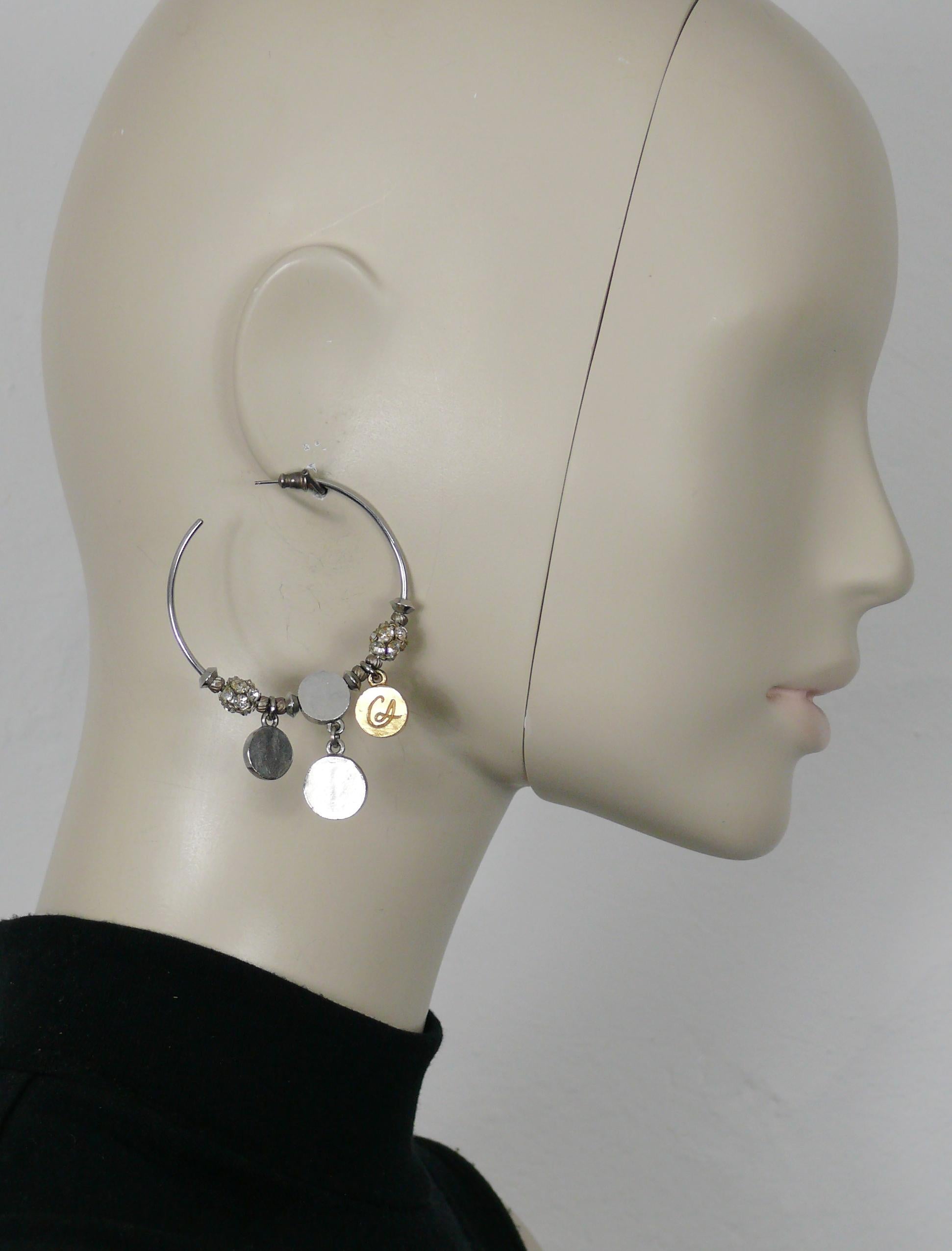 CHRISTIAN LACROIX vintage silver tone hoop earrings (for pierced ears) embellished with clear crystal balls, silver tone and gold tone charms (one embossed with the CL monogram), metal beads.

Unmarked (embossed CL on the gold tone