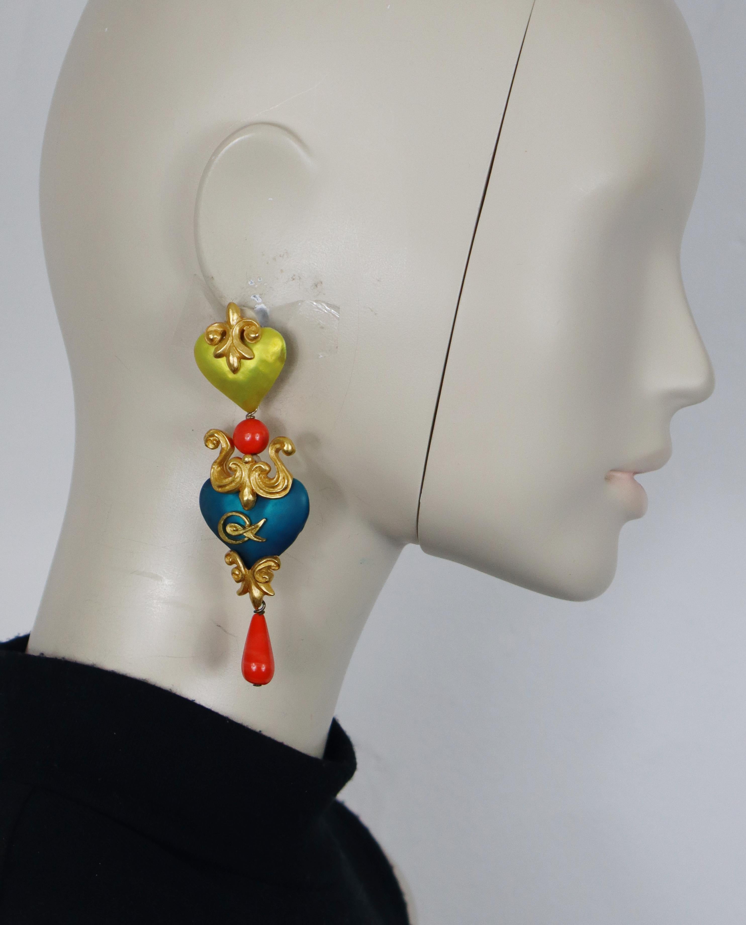 CHRISTIAN LACROIX vintage dangle earrings (clip-on) featuring two enamel hearts, gold tone metal ornaments , CL monogram and glass beads.

Marked CHRISTIAN LACROIX CL Made in France.

Indicative measurements : max. height approx. 10.5 cm (4.13