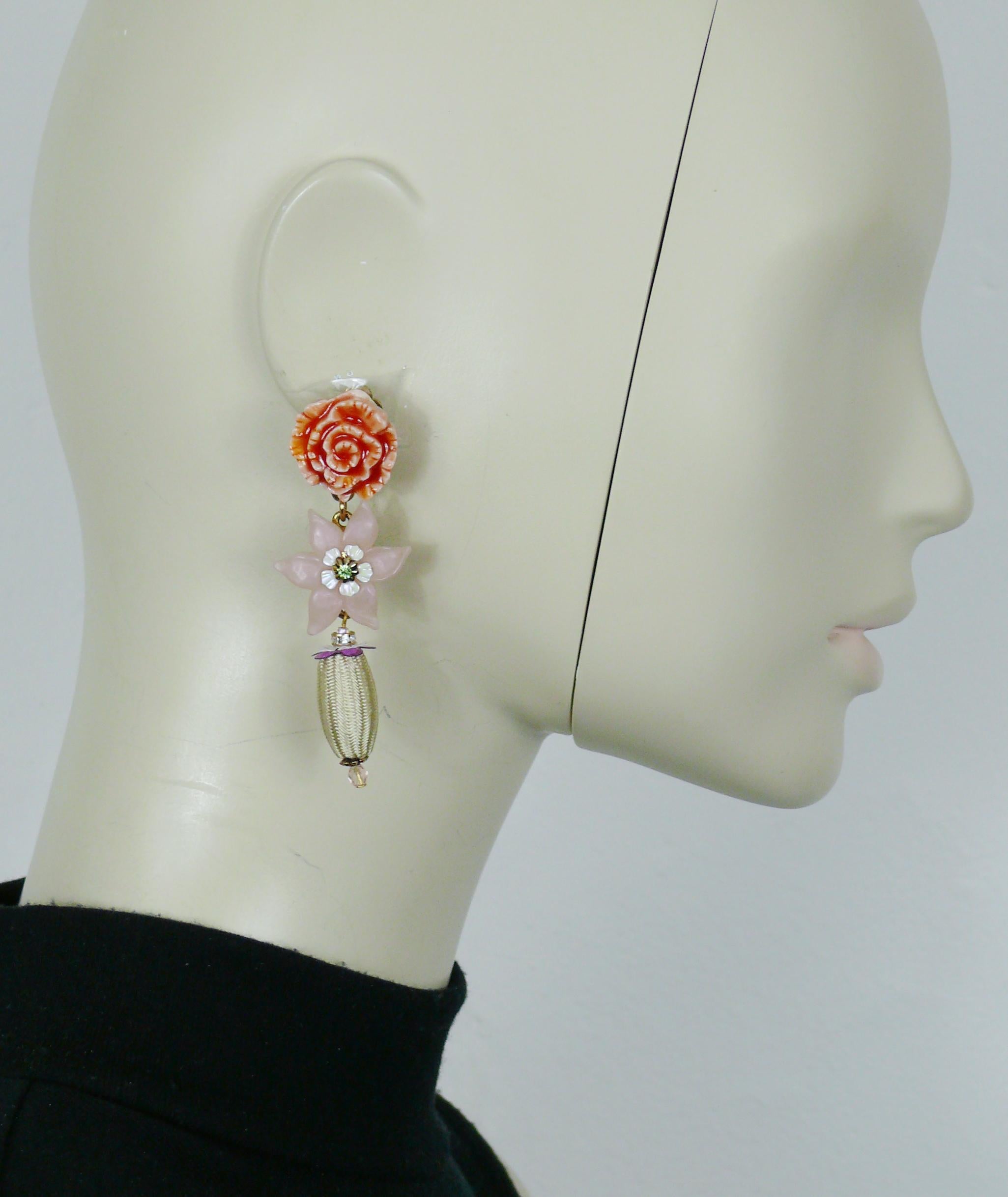 CHRISTIAN LACROIX vintage gold tone floral dangling earrings (clip-on) featuring a a porcelain flower top, a pink iridescent flower embellished with a green crystal and an olive-shaped fabric charm.

Marked CHRISTIAN LACROIX CL Made in