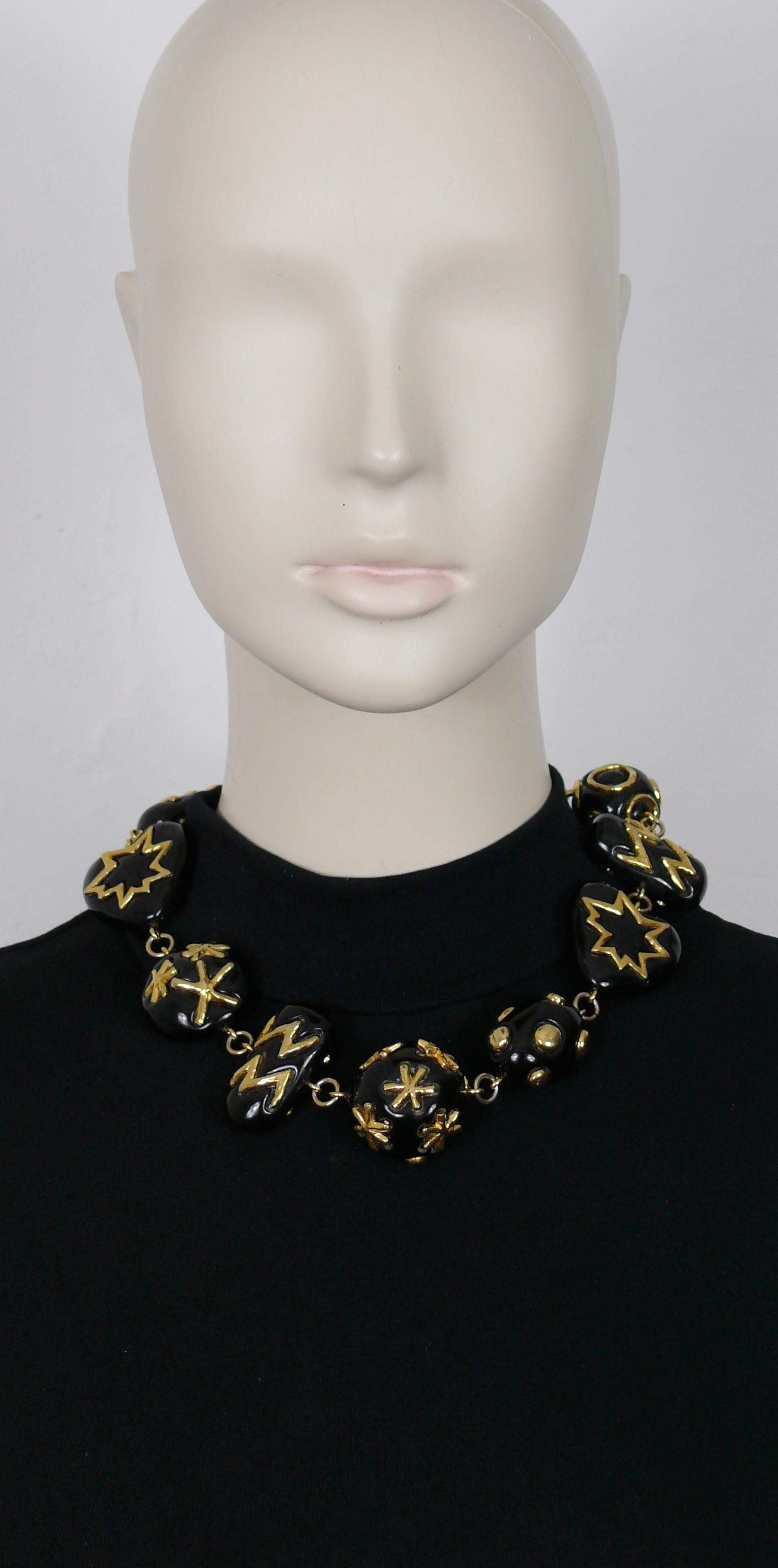 CHRISTIAN LACROIX vintage necklace featuring large black resin links of various shapes (rectangular, hearts, pebble, balls) with gold toned embellishement.

T-bar and toggle closure.

Marked CHRISTIAN LACROIX CL Made in France.

Indicative