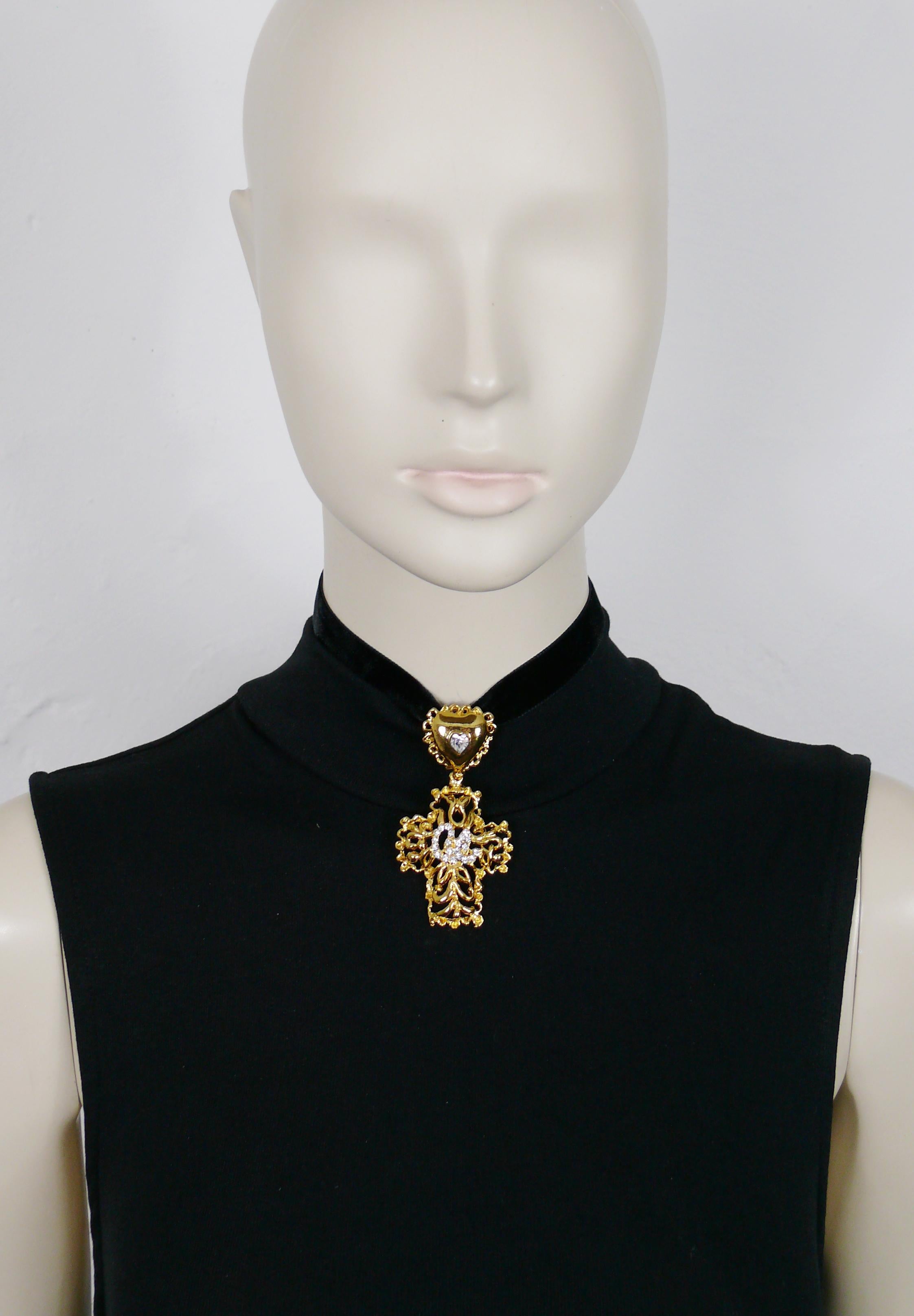 CHRISTIAN LACROIX vintage gold toned openwork cross pendant featuring the CL monogram embellished with clear crystals, topped by a jewelled heart bail.

Comes with a black velvet ribbon (ties at back).

Marked CHRISTIAN LACROIX CL Made in