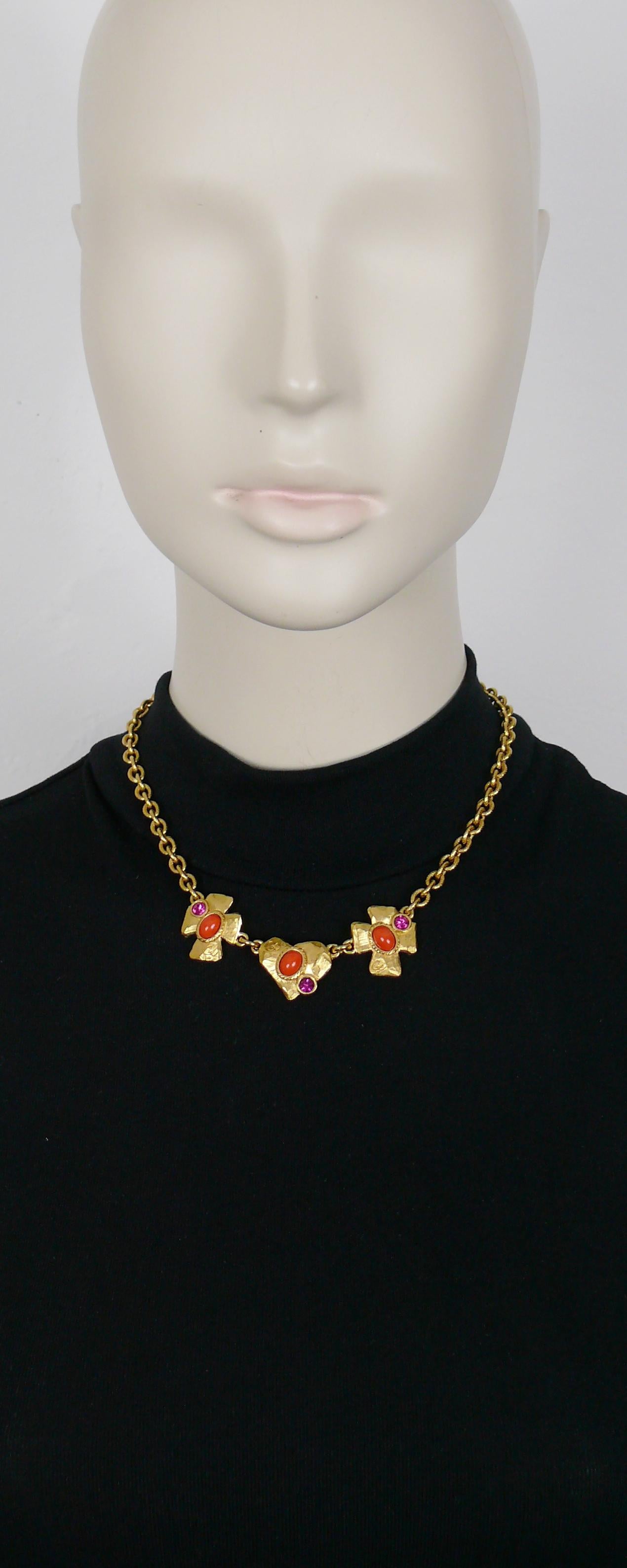 CHRISTIAN LACROIX vintage gold toned chain necklace featuring two crosses and a heart embellished with orange glass cabochons, fuchsia pink crystals and engraved with the CL monogram.

Marked CHRISTIAN LACROIX CL Made in France.

Indicative