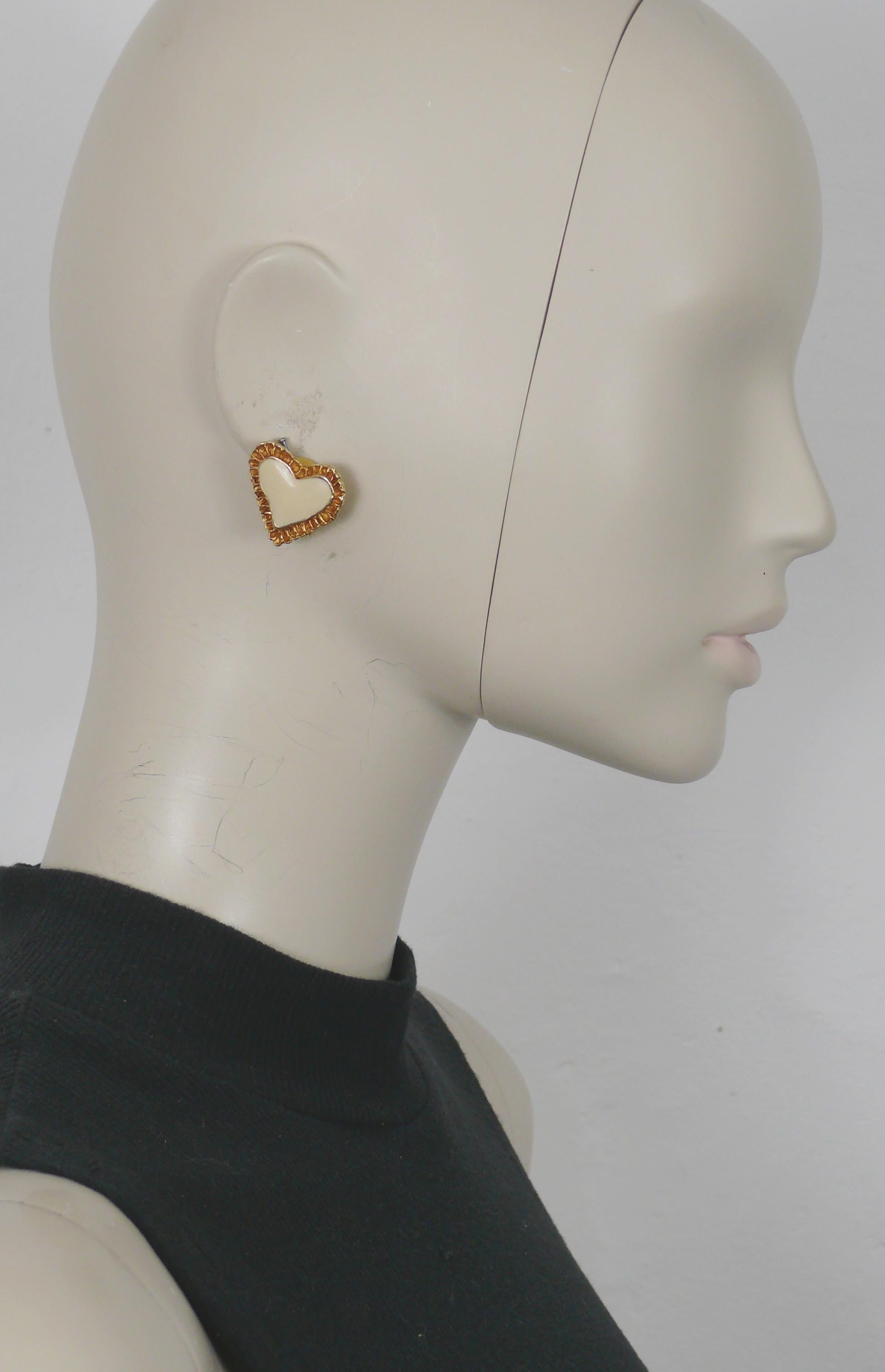 CHRISTIAN LACROIX vintage gold toned textured heart clip-on earrings embellished with off-white enamel.

Marked CHRISTIAN LACROIX E94 Made in France.

Indicative measurements : height approx. 2.1 cm (0.83 inch) / max. width approx 2.5 cm (0.98