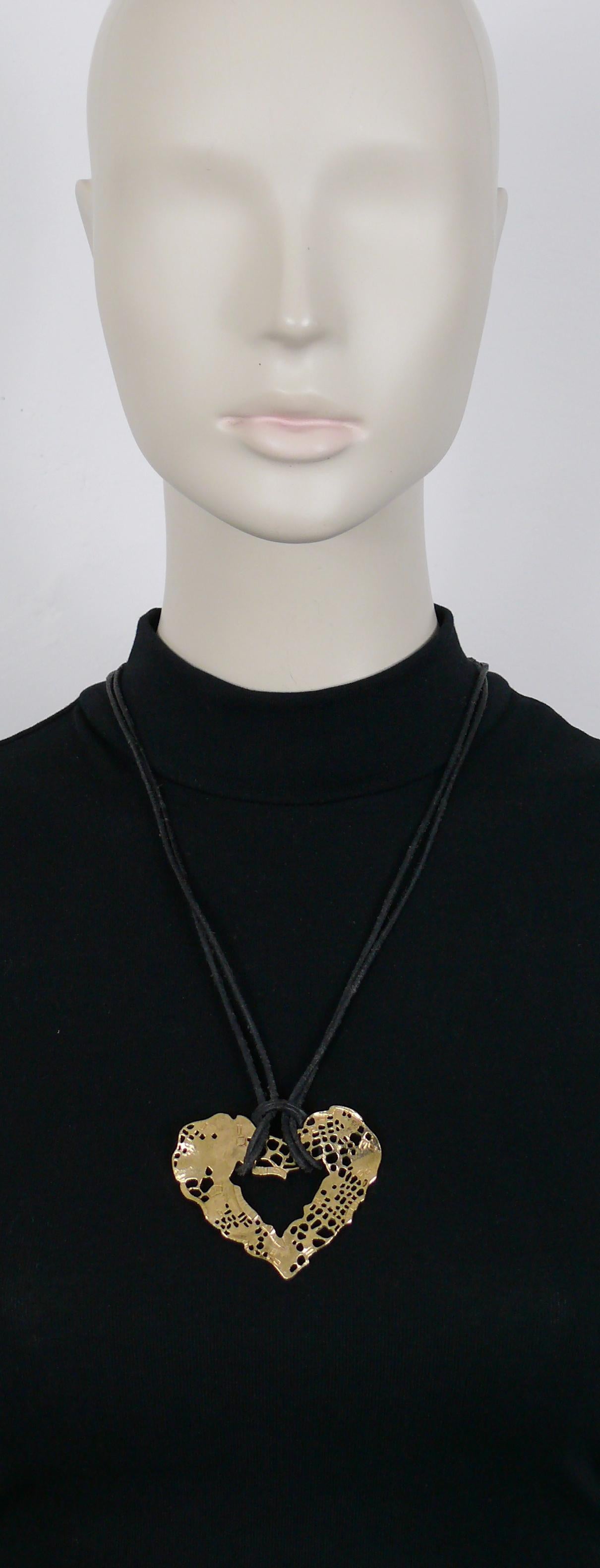 CHRISTIAN LACROIX vintage black leather cords necklace featuring a gold toned perforated heart pendant.

Slips on.
Sliding ball element to to adjust the length.

Marked CHRISTIAN LACROIX CL Made in France.

Indicative measurements : max. wearable