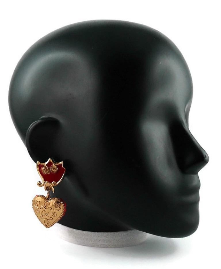 CHRISTIAN LACROIX vintage gold toned heart dangling earrings (clip-on) featuring a Baroque desing embellished with red enamel.

Reverse of the heart is covered with red sequins.
Hearts can be easily returned.

Marked CHRISTIAN LACROIX CL Made in
