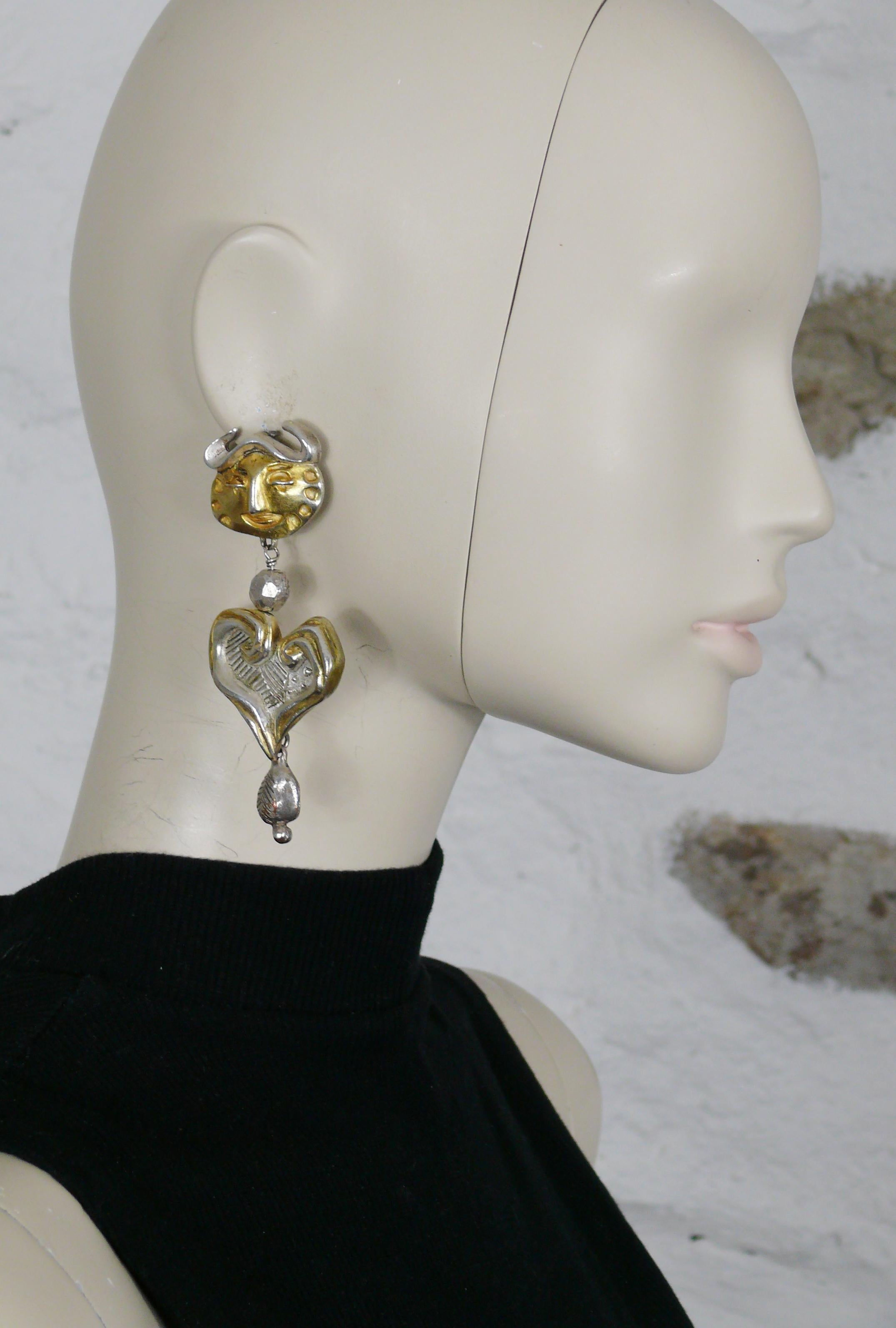 CHRISTIAN LACROIX iconic antiqued bi-toned (gold tone and silver tone) metal dangling earrings (clip-on) featuring an human bull head and a brutalist heart.

Marked CHRISTIAN LACROIX CL Made in France.

Indicative measurements : max. height approx.