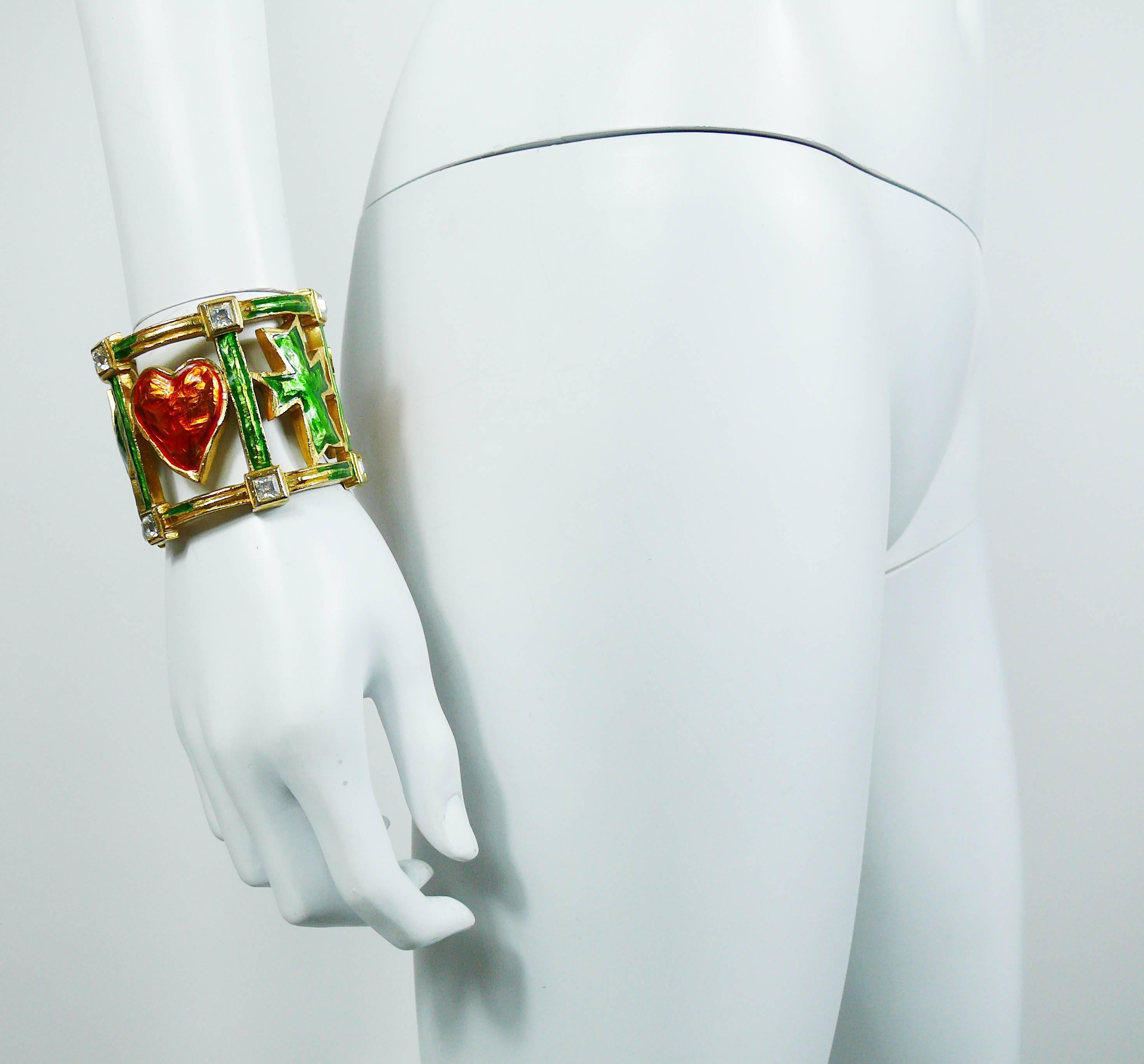CHRISTIAN LACROIX vintage gold tone cuff bracelet featuring enameled iconic symbols and clear crystal embellishement.

Marked CHRISTIAN LACROIX CL Made in France.

Indicative measurements : inner circumference approx. 17.91 cm (7.05 inches) / width