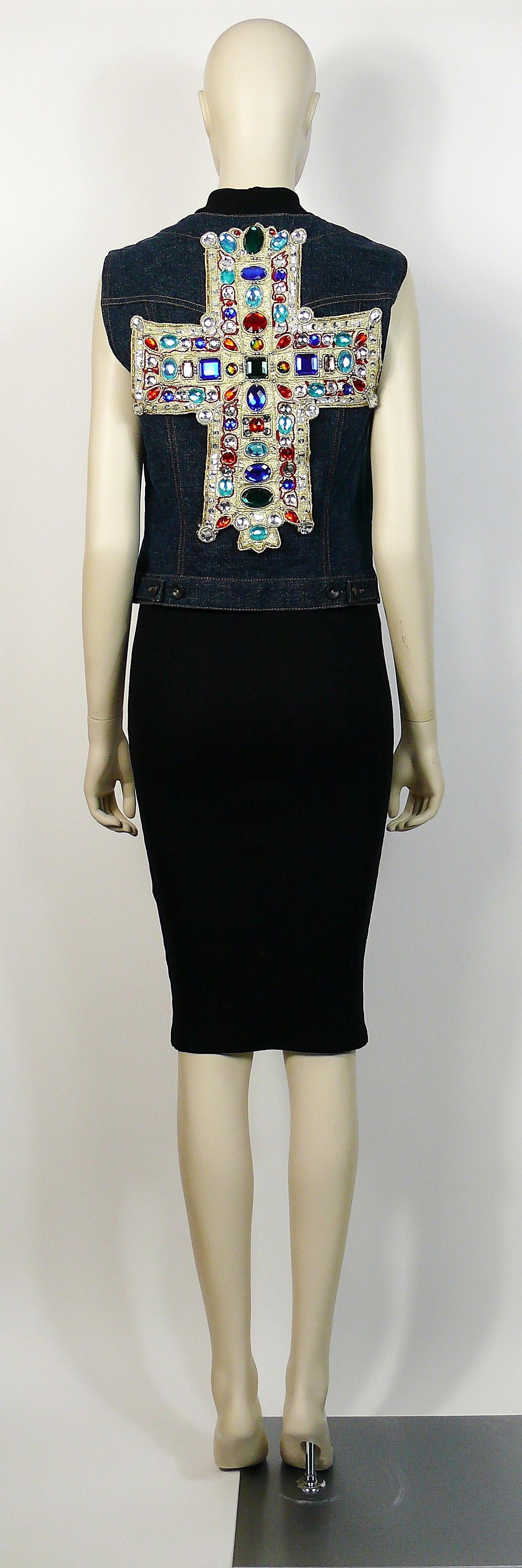 CHRISTIAN LACROIX vintage iconic denim vest enblazoned on the back by a Medieval inspired gold cross embellished with multicolored resin stones in varying shapes and sizes, faux pearls and sequins.

The cross is removable.

Label reads 15 CHRISTIAN