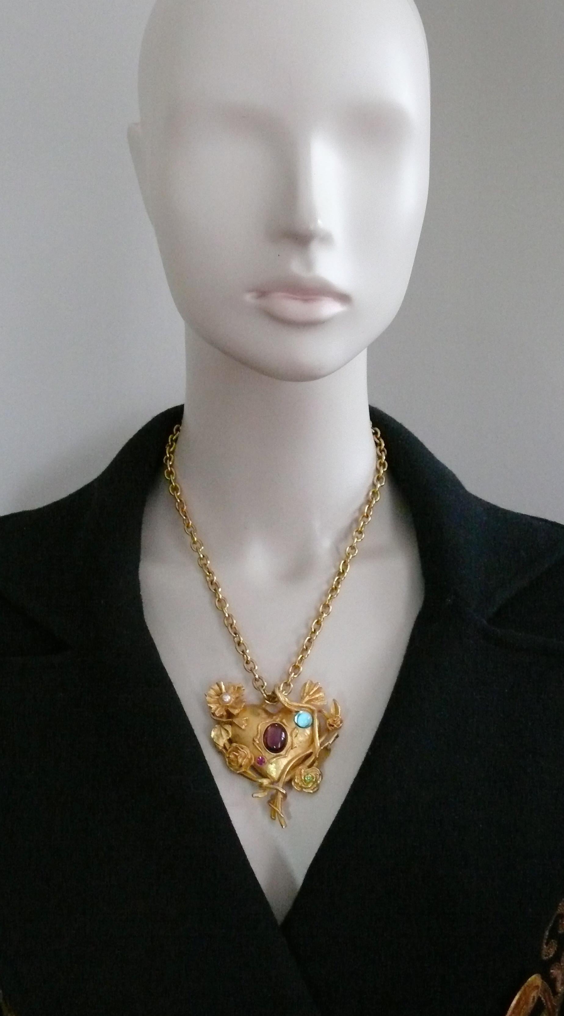 CHRISTIAN LACROIX vintage gold toned chain pendant necklace featuring a jewelled and mirrored floral heart embellished with blue and purple glass cabochons, faux pearl and multicolored crystals.

Adjustable hook closure.

Marked CHRISTIAN LACROIX CL