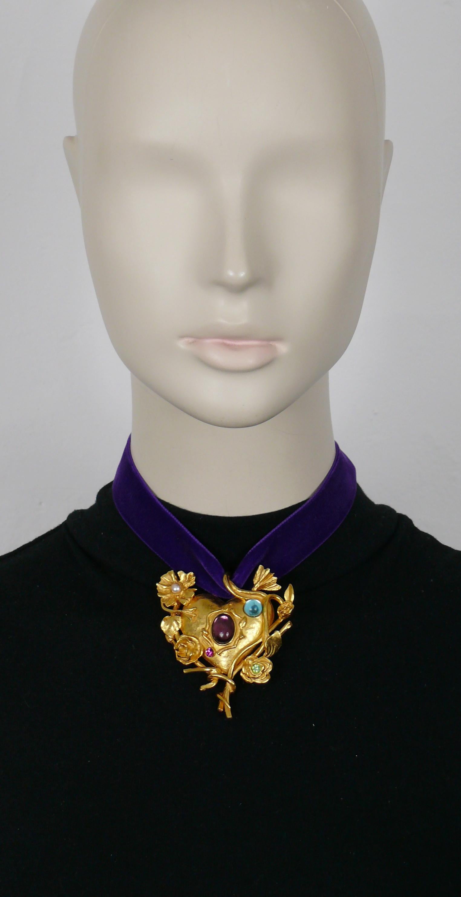 CHRISTIAN LACROIX vintage pendant necklace featuring a jewelled and mirrored floral heart embellished with blue and purple glass cabochons, faux pearl and multicolored crystals. Original purple velvet ribbon (ties at the neck).

Marked CHRISTIAN