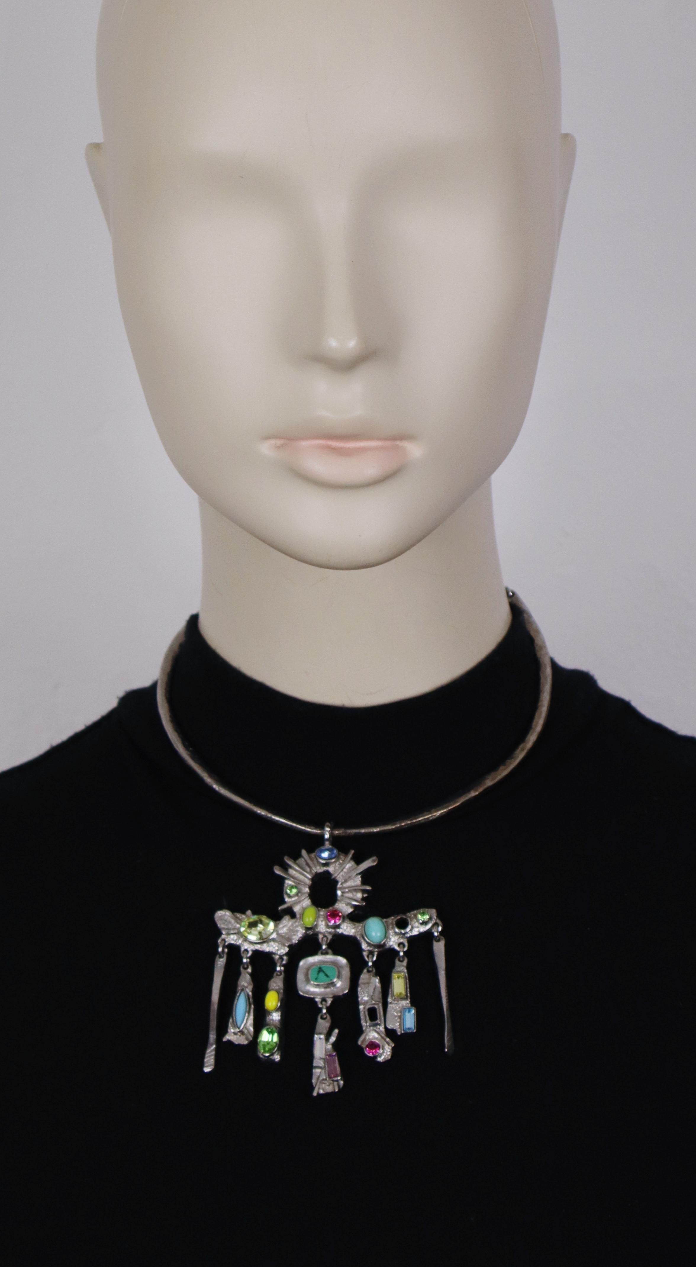 CHRISTIAN LACROIX vintage textured silver tone torque necklace featuring a modernist pendant embellished with multicoloured crystals and resin cabochons.

Adjustable hook clasp closure.

Marked CHRISTIAN LACROIX CL Made in France.

Indicative