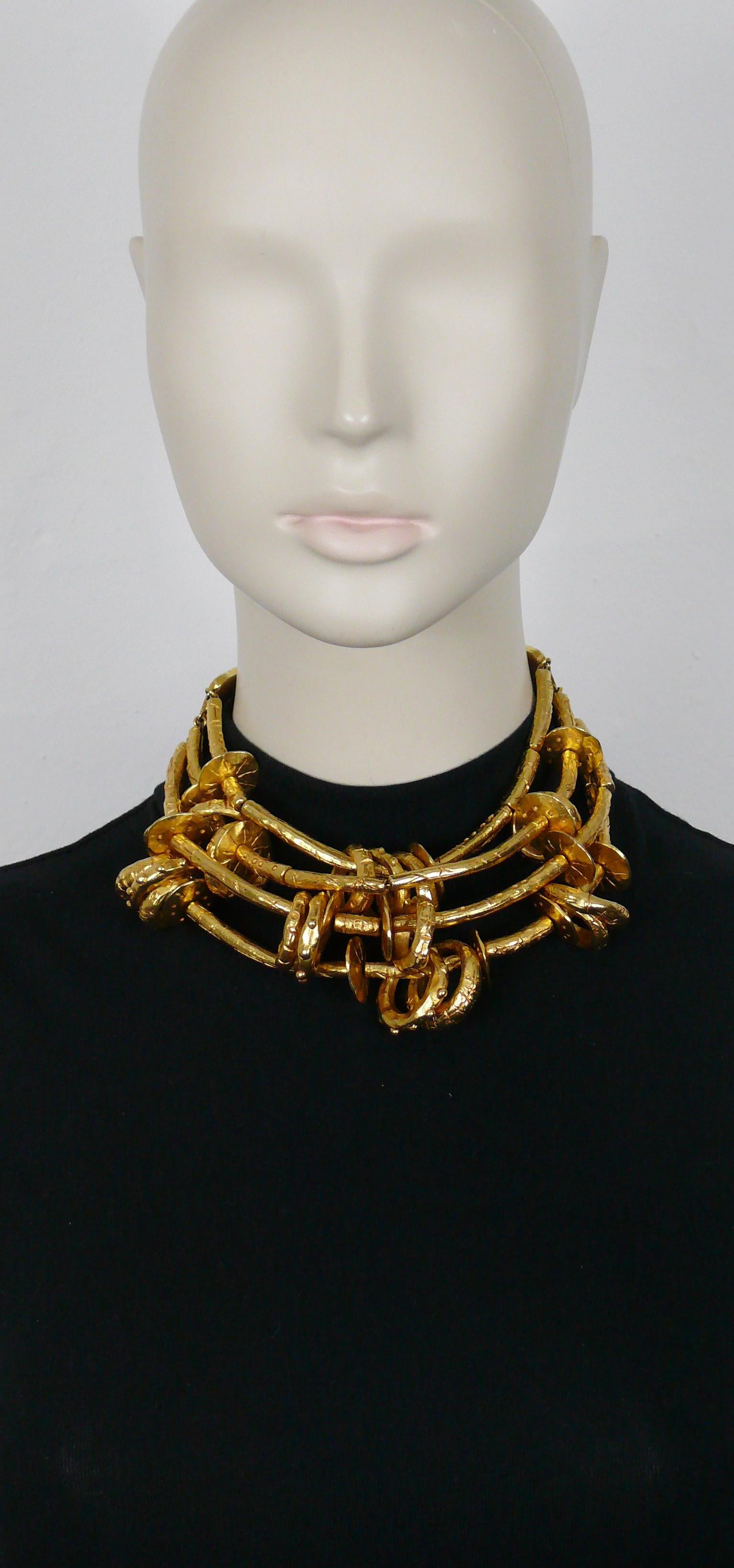 CHRISTIAN LACROIX vintage rare massive ethnic tribal inspired four strands gold tone choker necklace featuring scarified links and rings. Both ends are made of deep red studded leather embellished with orange resin cabochon.

Hook clasp