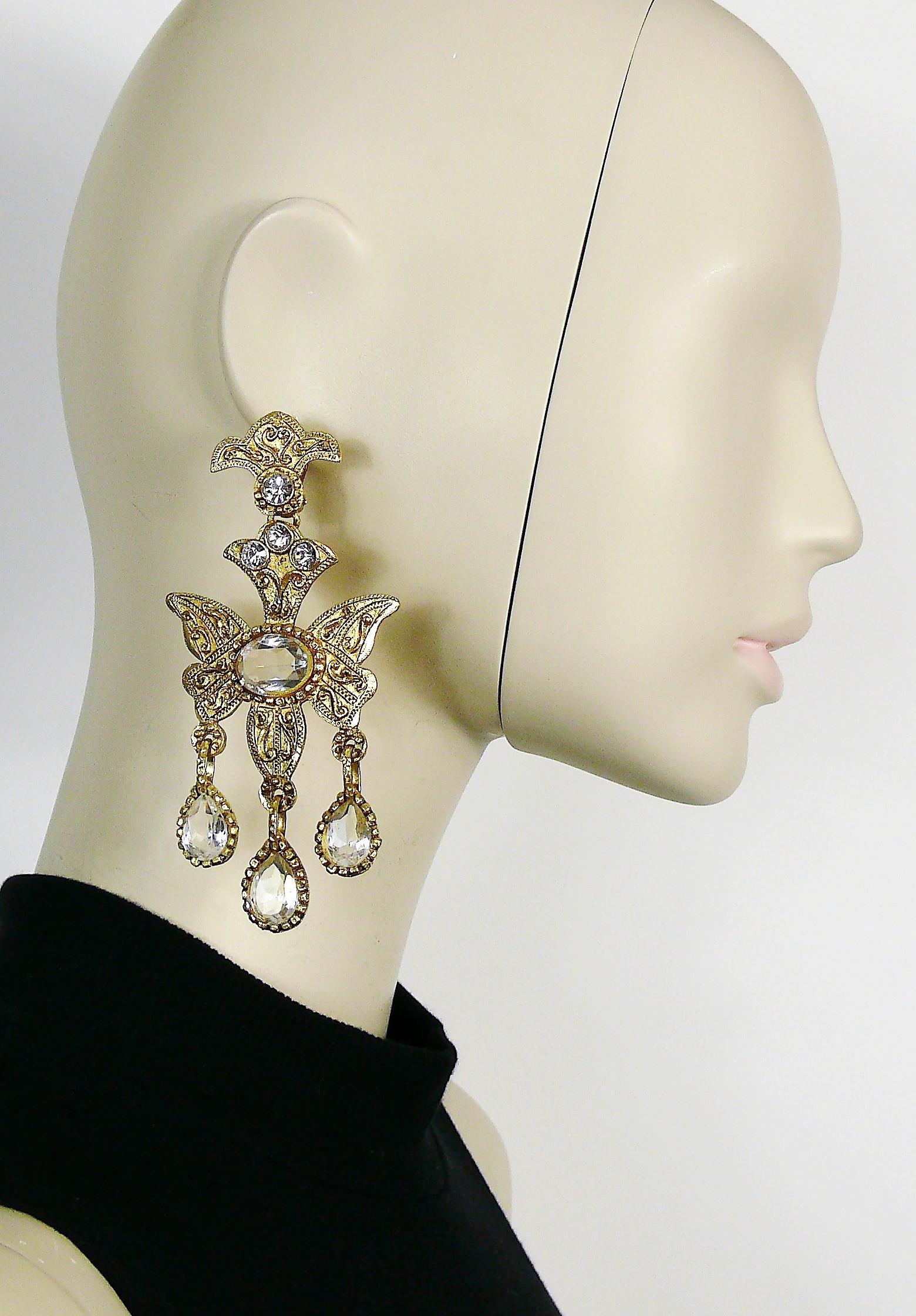 CHRISTIAN LACROIX vintage massive gold toned chandelier earrings (clip-on) featuring a stylized butterfly embellished with arabesques, friezes, and white crystals.

Marked CHRISTIAN LACROIX CL Made in France.

Indicative measurements : max. height