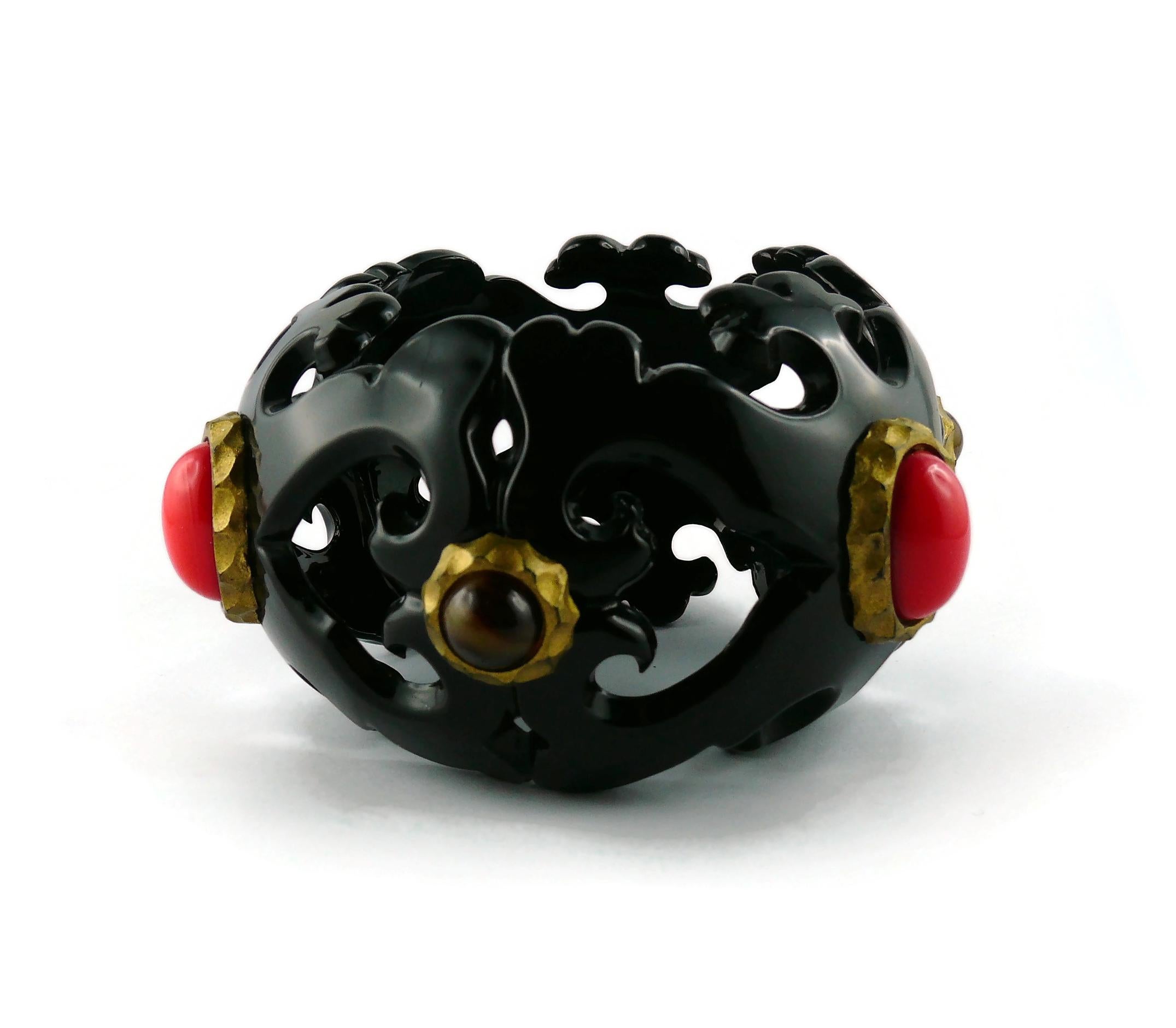 CHRISTIAN LACROIX rare vintage massive black resin cuff bracelet featuring a gorgeous openwork design of scrolls and hearts embellished with faux tiger eye stones and faux red coral resin cabochons.

Marked CHRISTIAN LACROIX CL Made in