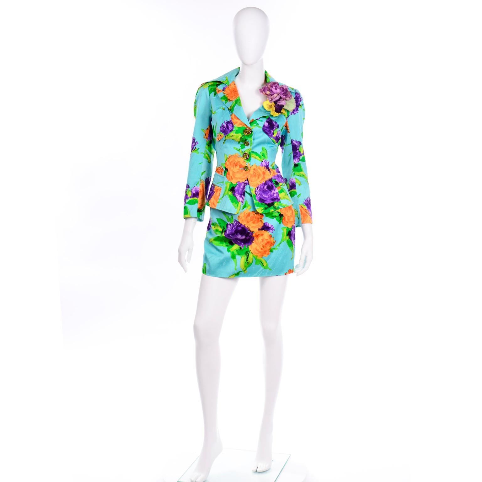 We love this bold, colorful Christian Lacroix floral print skirt suit in shades of turquoise, orange, purple, and green. This suit is such a  versatile ensemble, as it can be worn not only as a suit,  but  as fun separates with other pieces!  The