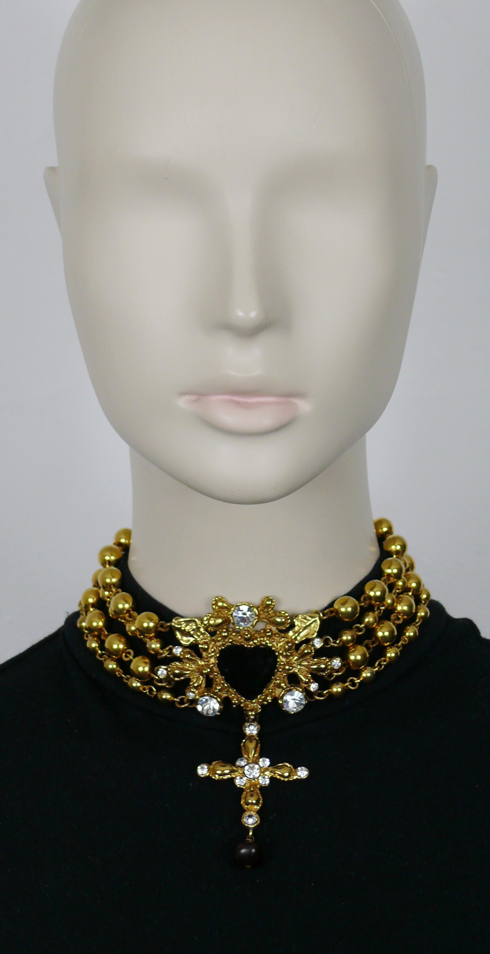 CHRISTIAN LACROIX vintage gold tone multistrand ball chain choker necklace featuring a black velvet heart centerpiece, a dangling cross, with clear crystals embellishement.

Adjustable hook clasp closure.

Marked CHRISTIAN LACROIX CL Made in