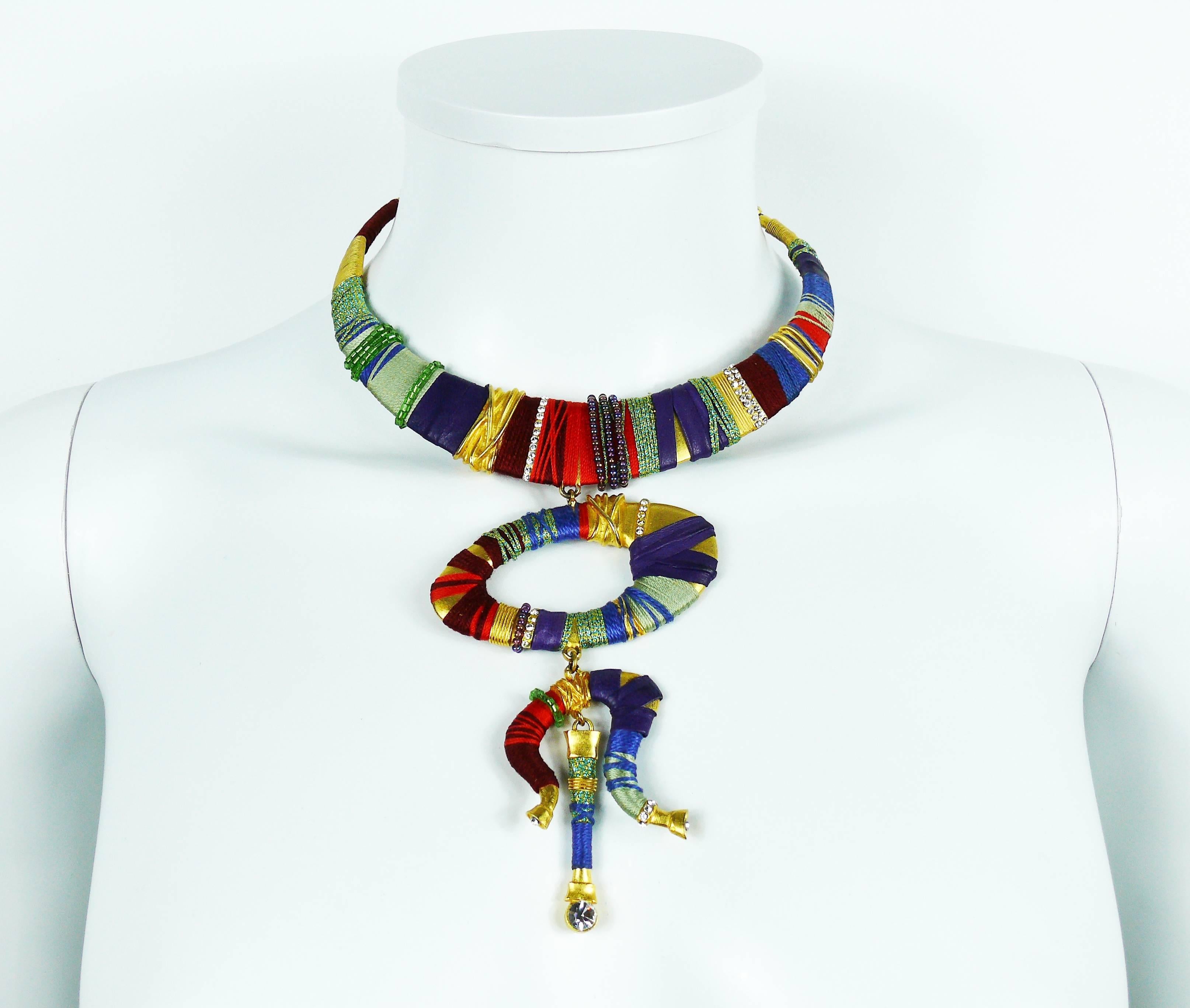 CHRISTIAN LACROIX vintage gorgeous and rare Masai inspired gold toned rigid torque bib necklace embellished with multicolored beads, fabrics, purple leather and clear crystals.

Marked CHRISTIAN LACROIX CL Made in France.

Indicative measurements :