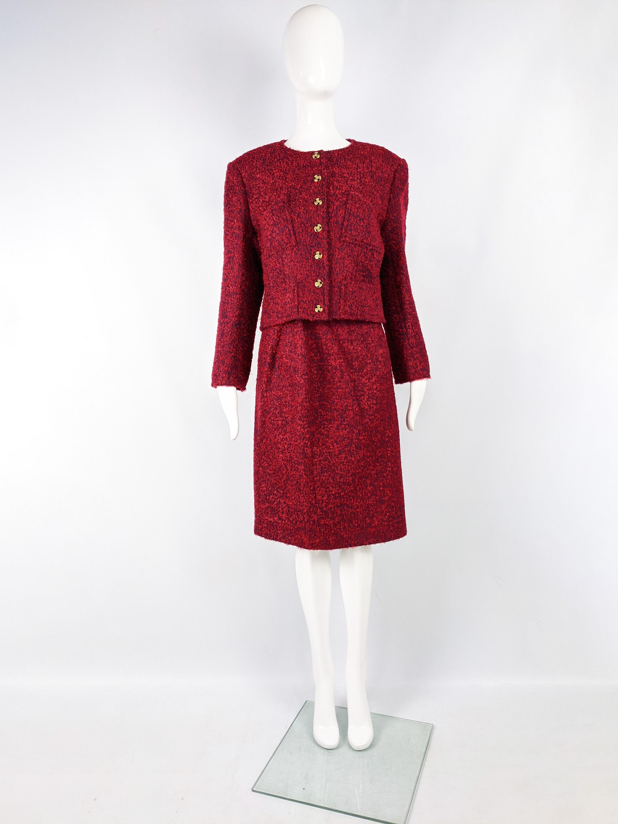 A chic vintage womens skirt suit from the 90s by luxury French fashion designer, Christian Lacroix. In a red and blue chunky mohair and wool tweed boucle fabric with statement buttons typical of lacroix. The blazer is collarless with light shoulder