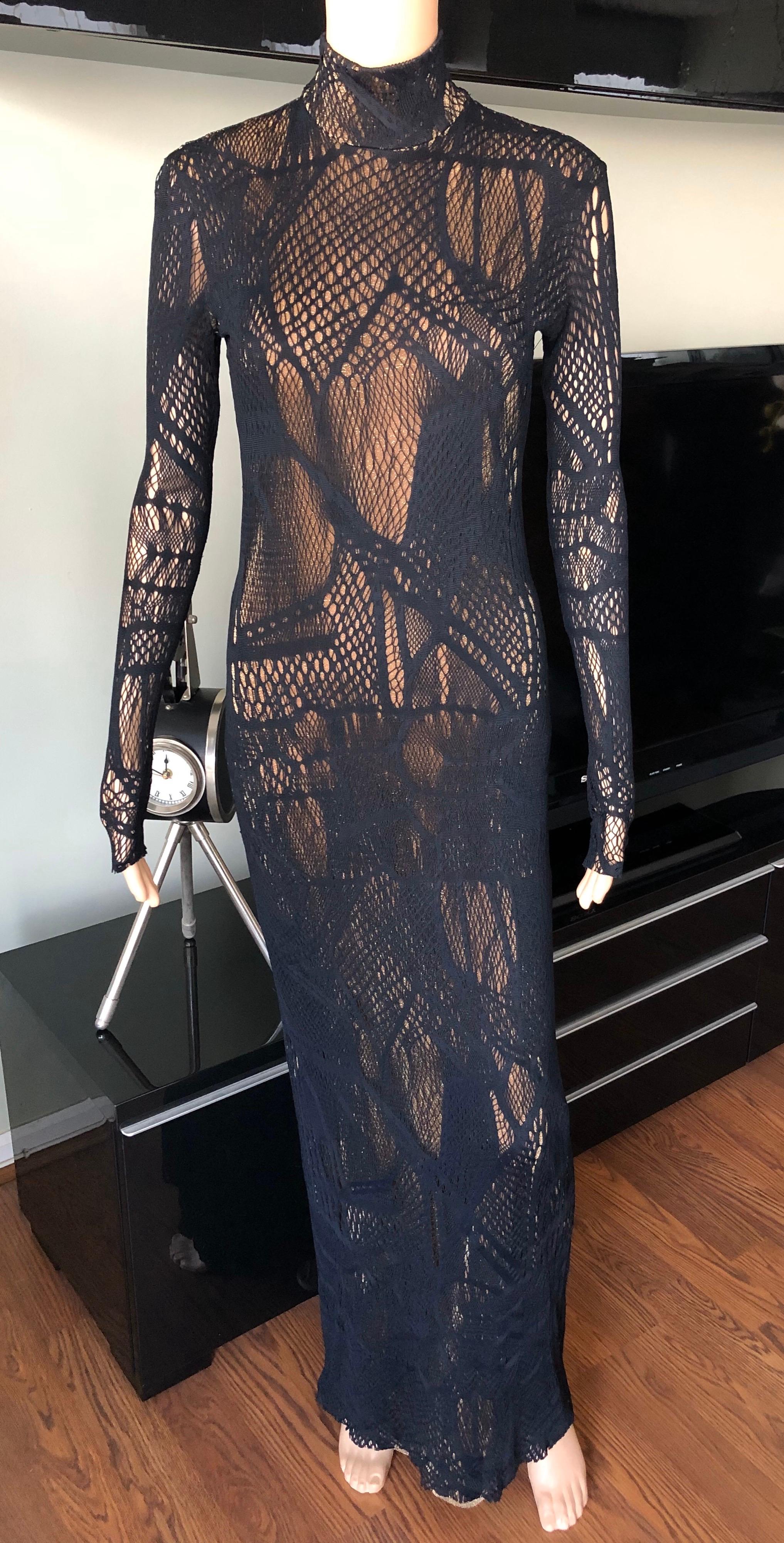 Christian Lacroix Vintage Semi-Sheer Mesh Open Knit Fishnet Black Maxi Dress FR 40

Christian Lacroix maxi dress featuring black fishnet pattern throughout, gold knit slip, mock neck, long sleeves and three button closures at back.
