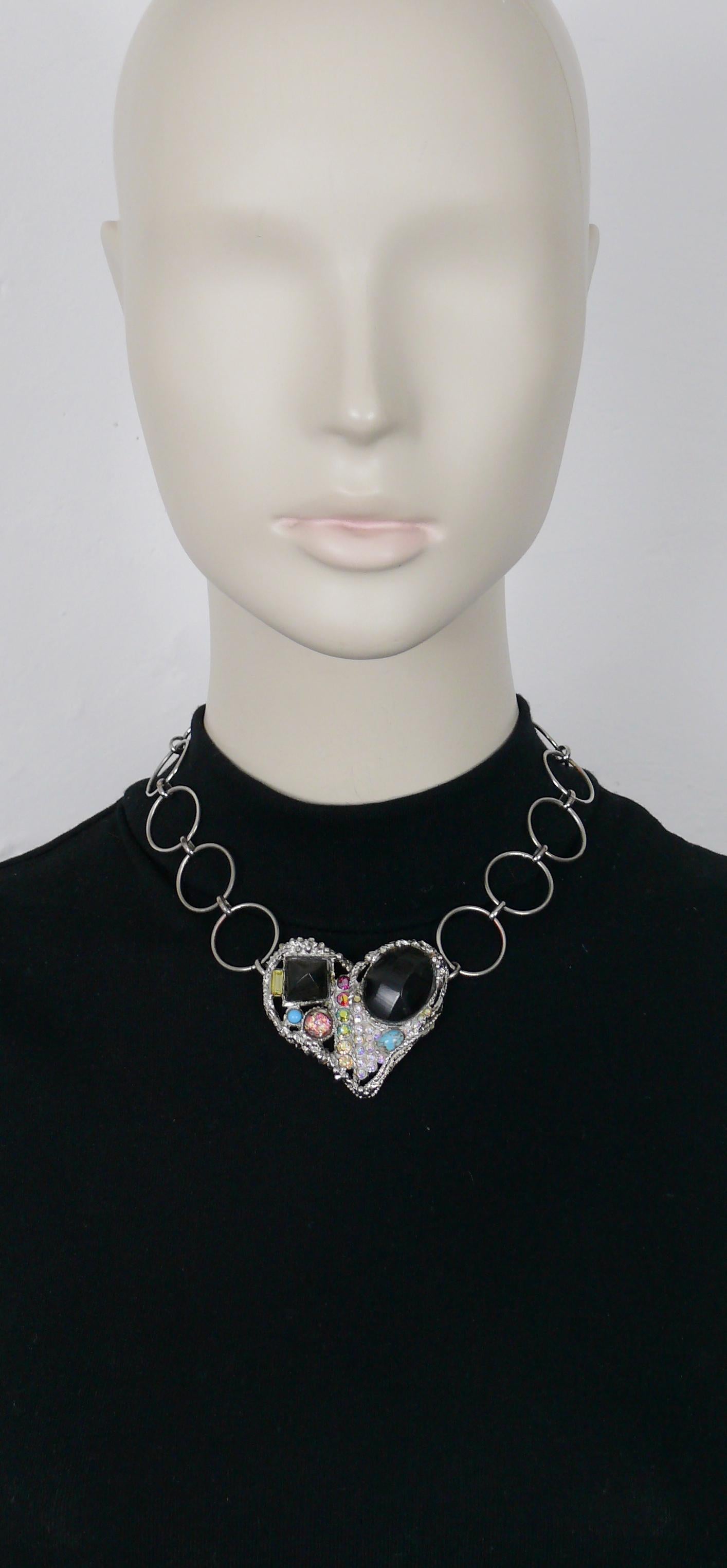 CHRISTIAN LACROIX vintage chain necklace featuring a textured brutalist heart embellished with multicolour crystals, glass cabochons and two faux horn elements.

Silver tone metal hardware.

Adjustable T-bar closure.

Marked CHRISTIAN LACROIX CL